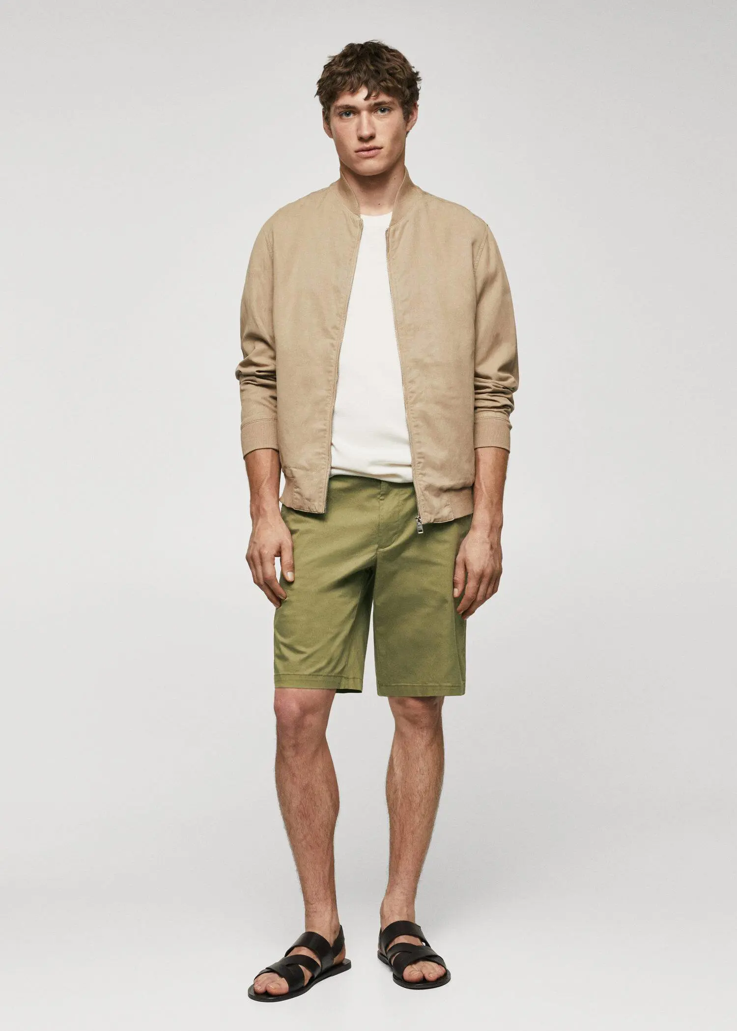 Mango Chino Bermuda shorts. a man in a tan jacket and green shorts. 