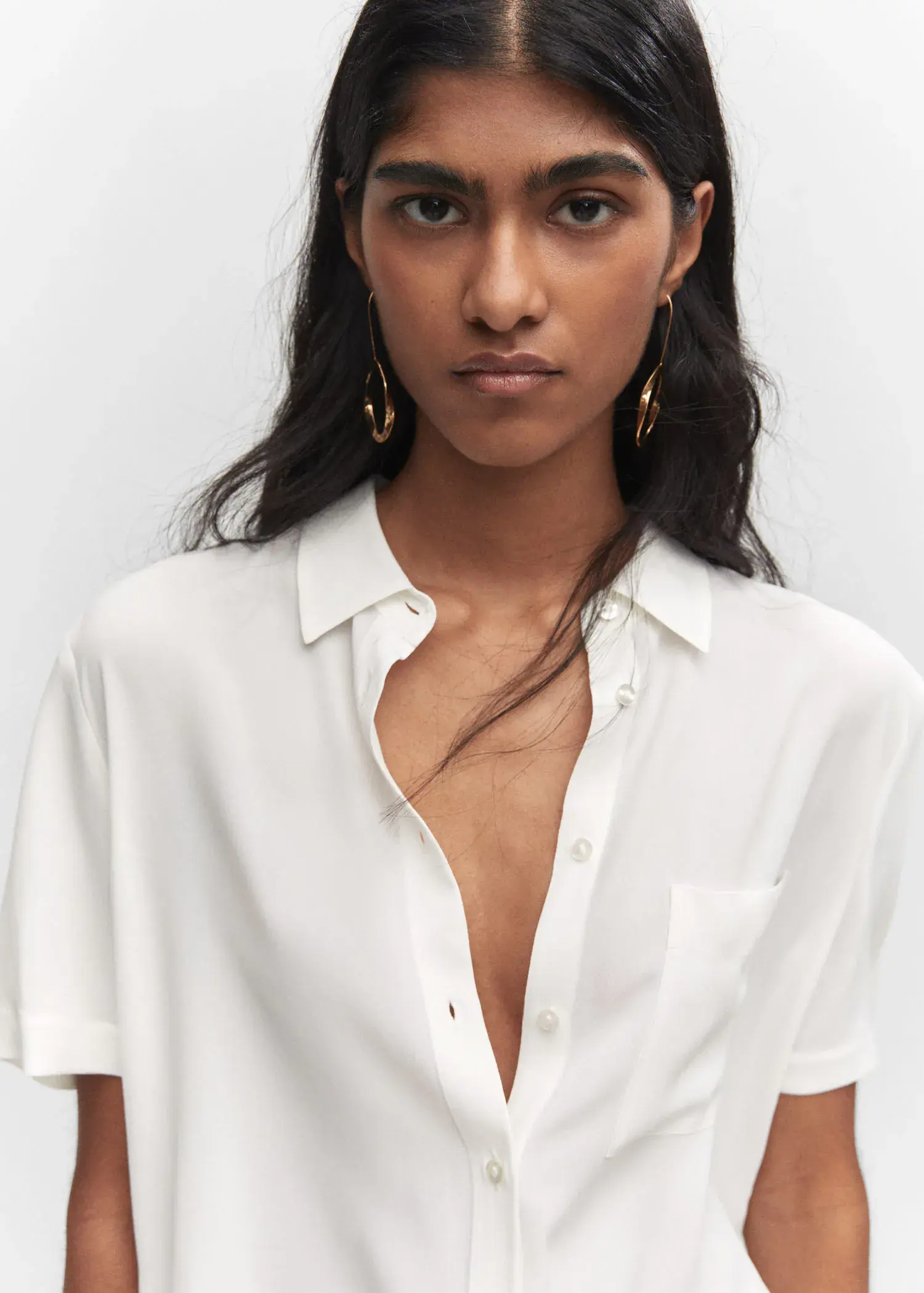 Mango Pocket oversize shirt. a woman wearing a white button up shirt. 