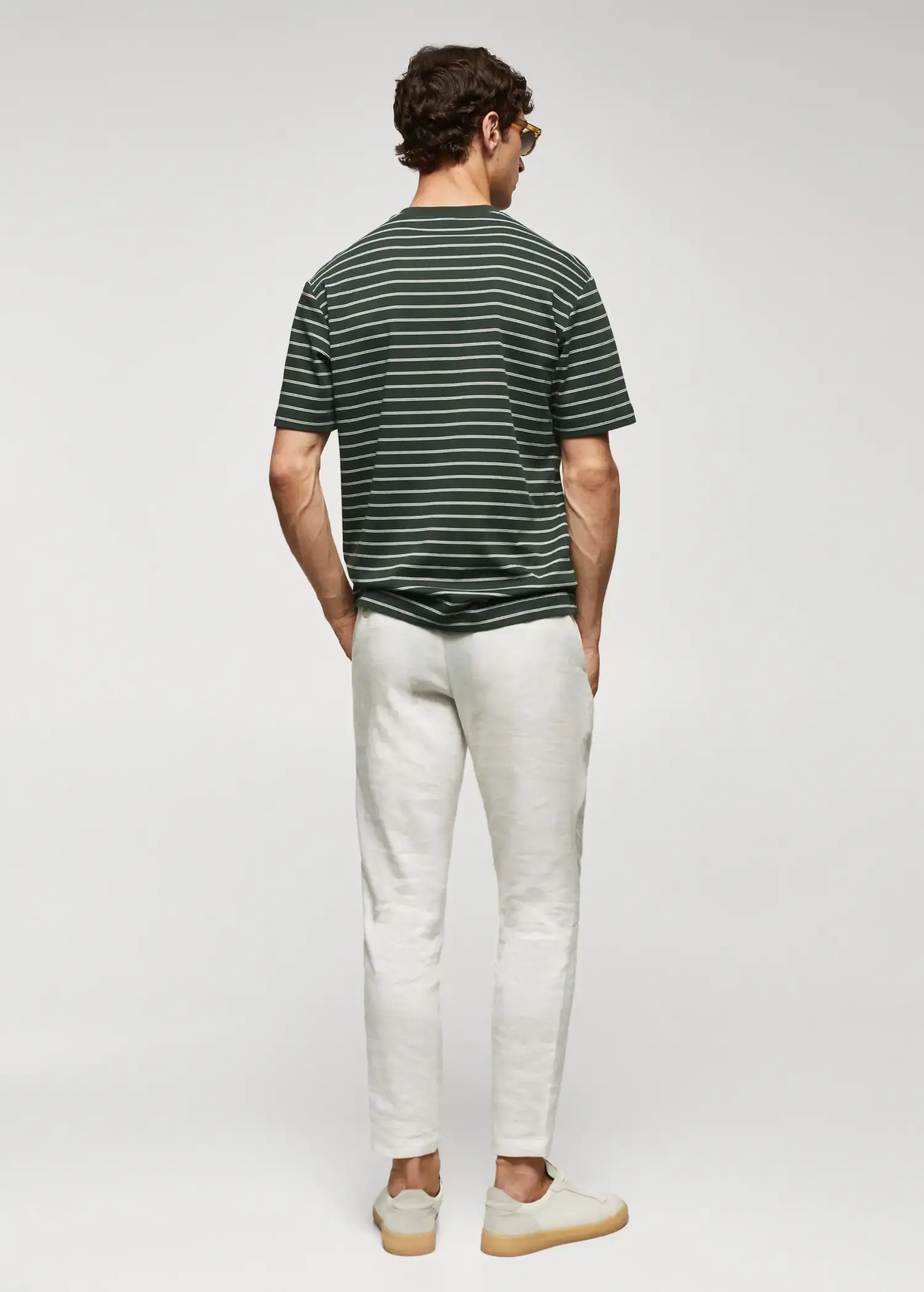 Mango Striped 100% cotton t-shirt. a man standing with his hands in his pockets. 