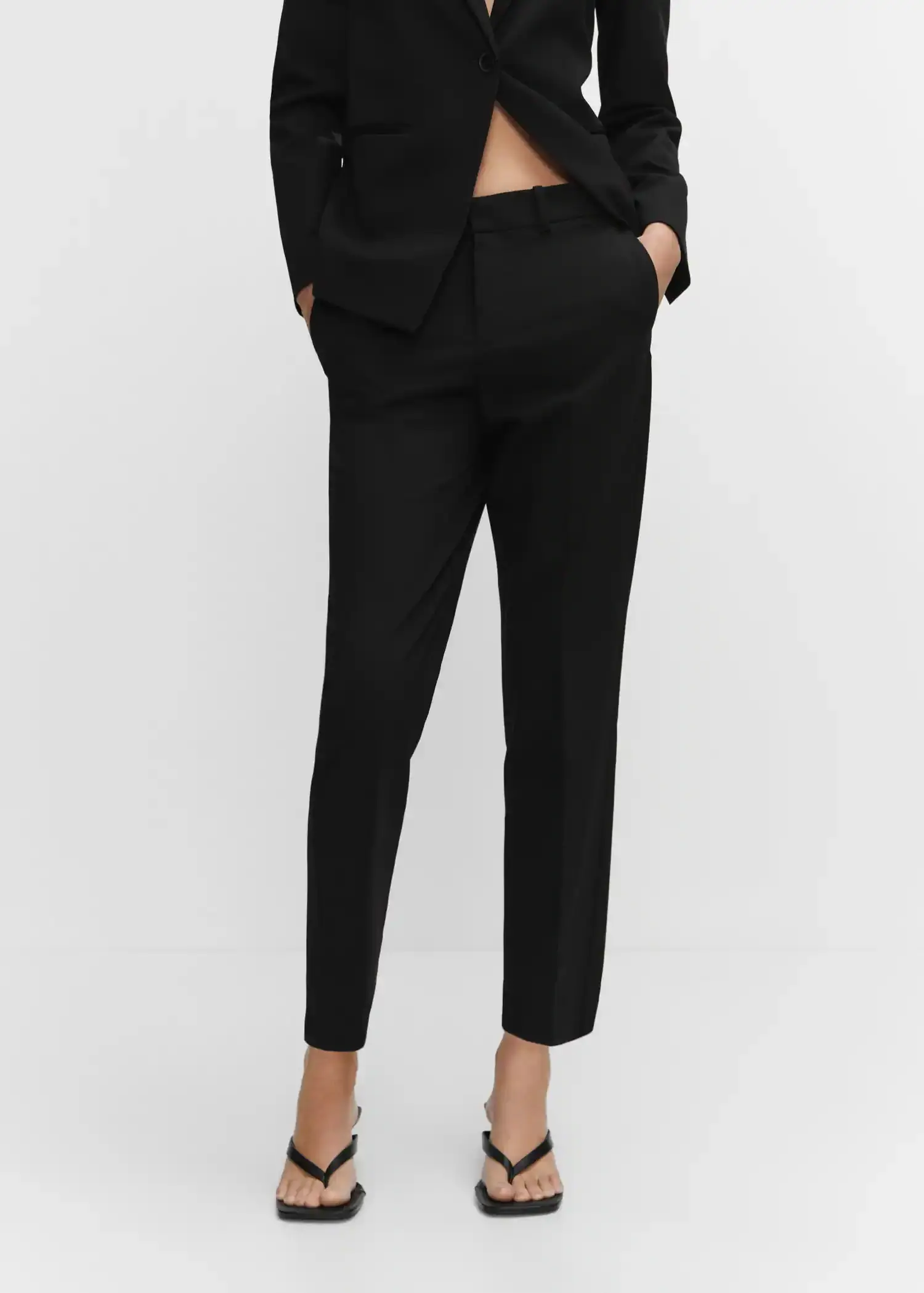 Mango Straight suit trousers. a person wearing black pants and a black shirt. 