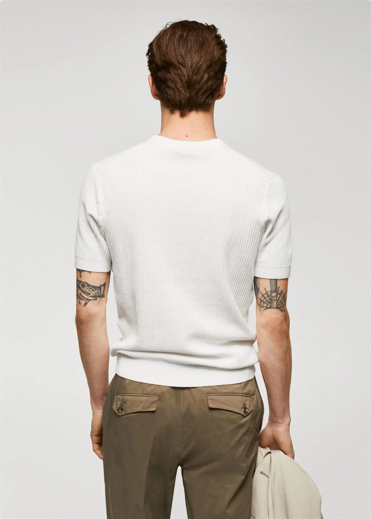 Mango 100% cotton t-shirt with ribbed structure. a man wearing a white shirt and brown shorts. 