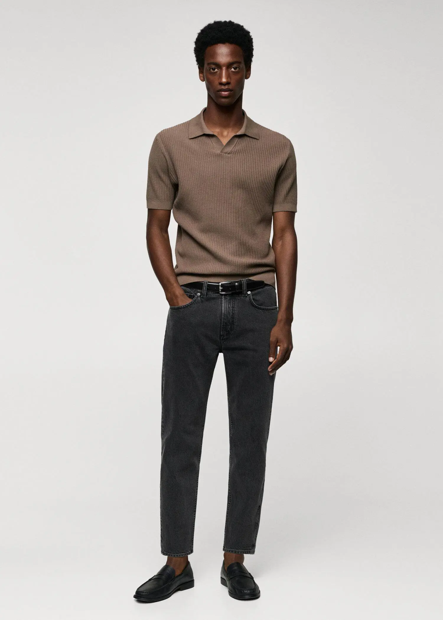 Mango Ben tapered cropped jeans. a man in a brown shirt and black pants. 