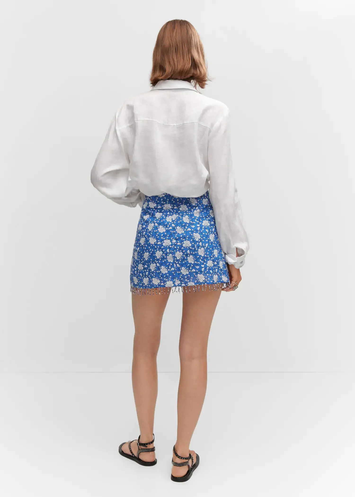 Mango Beaded printed mini-skirt. a woman wearing a white shirt and a blue skirt. 