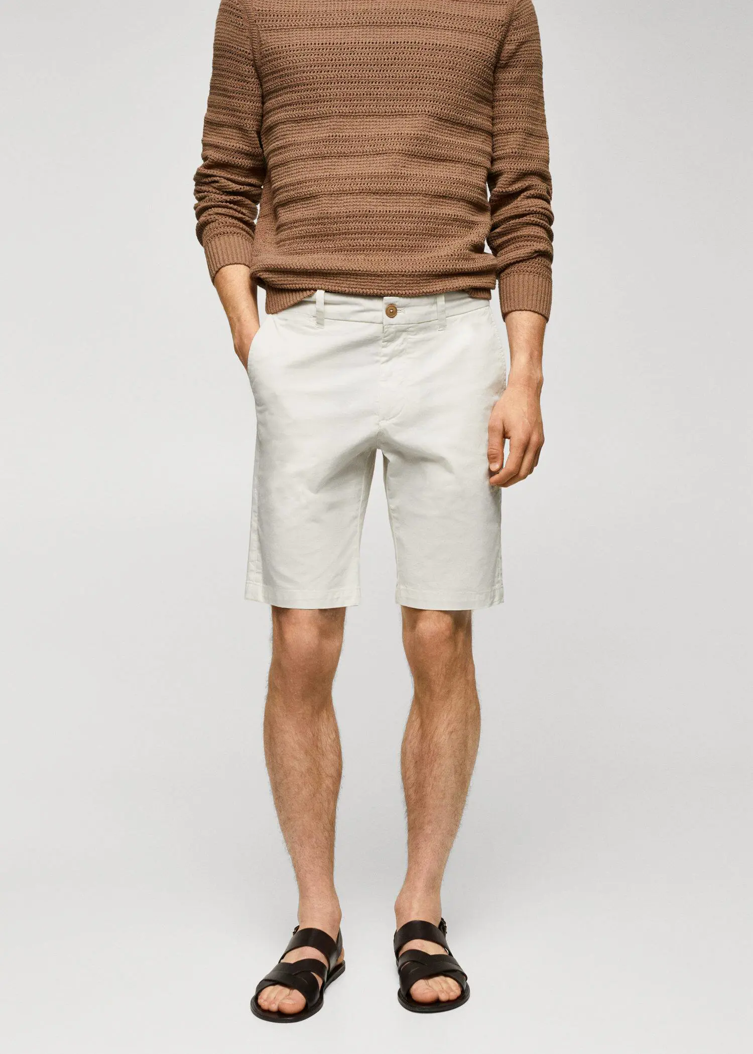 Mango Chino Bermuda shorts. a man in white shorts and a brown sweater. 