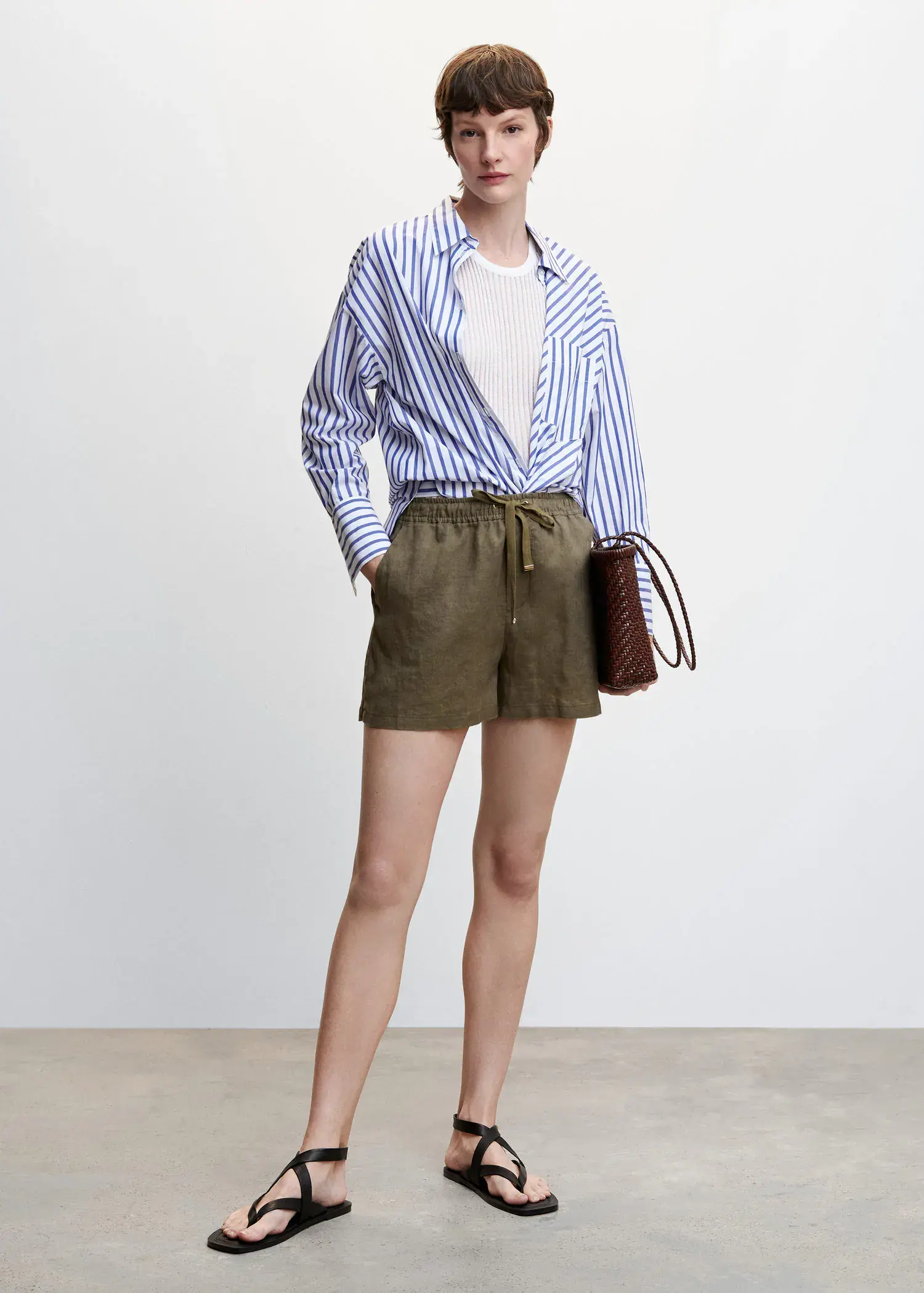 Mango Linen shorts with drawstring. a person wearing a striped shirt and shorts. 
