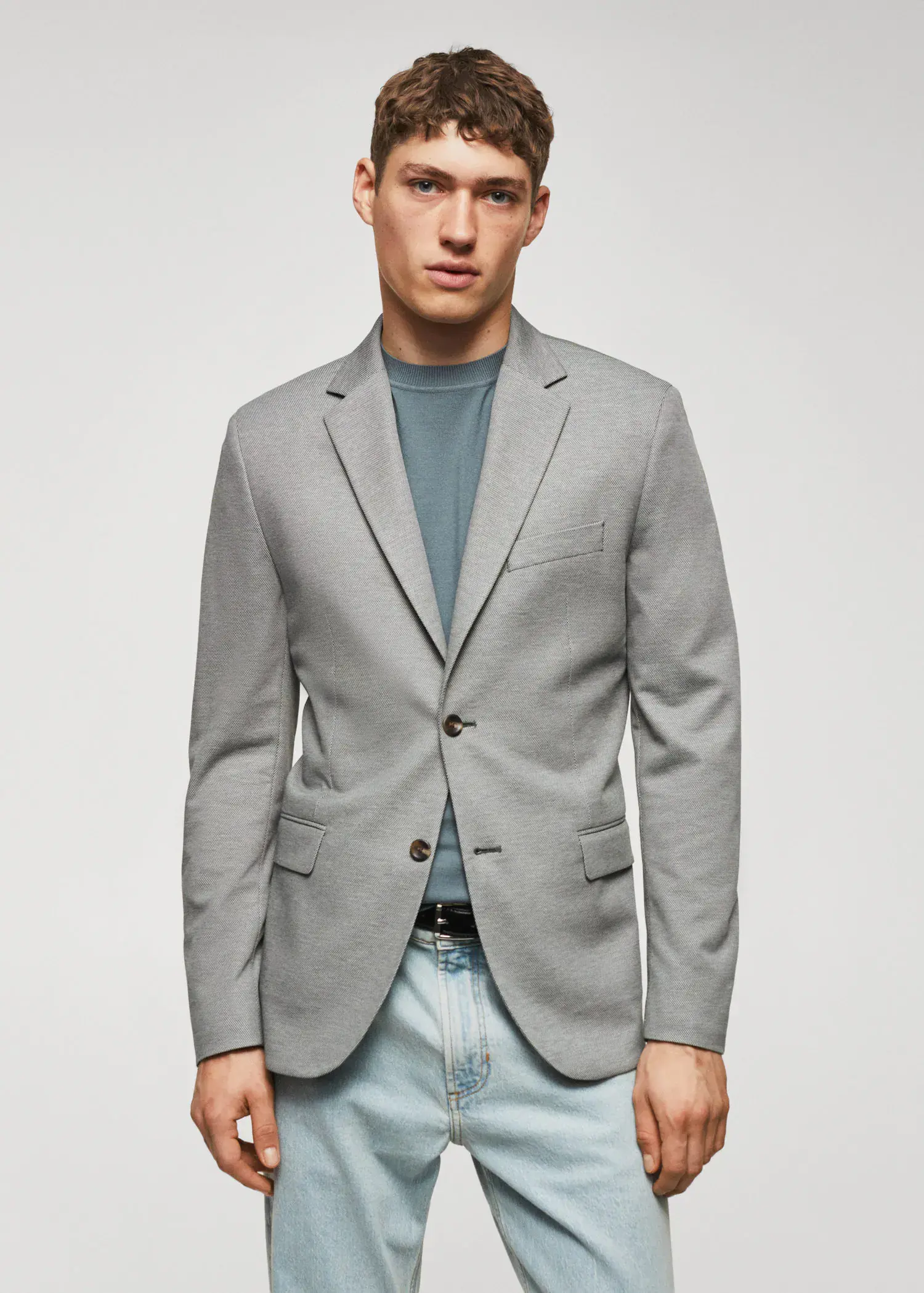 Mango Slim fit microstructure blazer. a man wearing a gray jacket and jeans. 