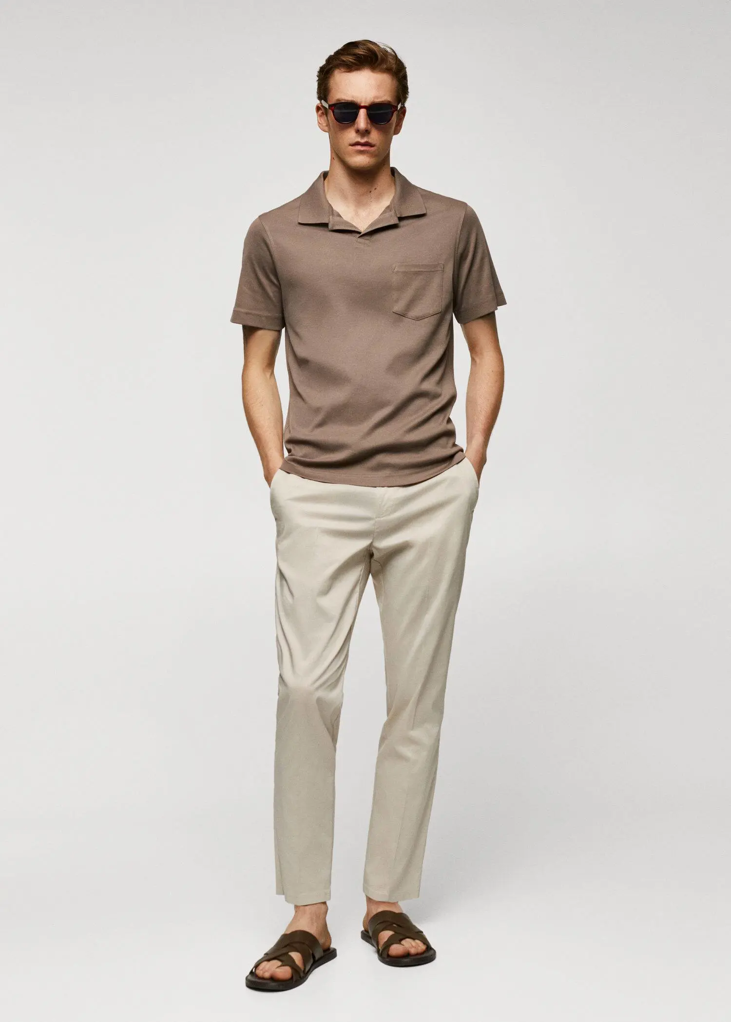 Mango 100% cotton polo shirt with pocket. a man in a brown shirt and beige pants. 