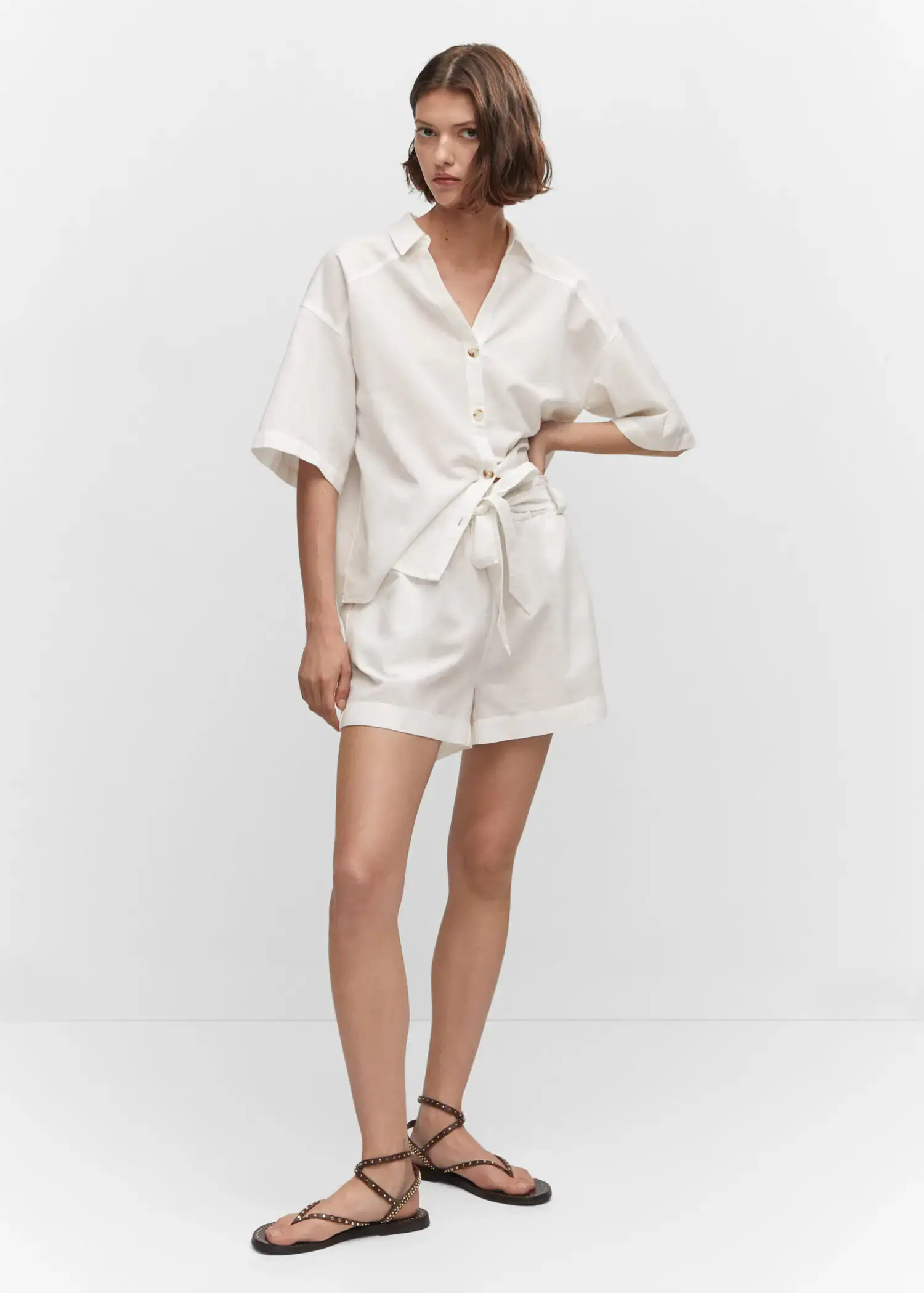 Mango Cotton linen shorts. a woman wearing a white shirt and shorts. 