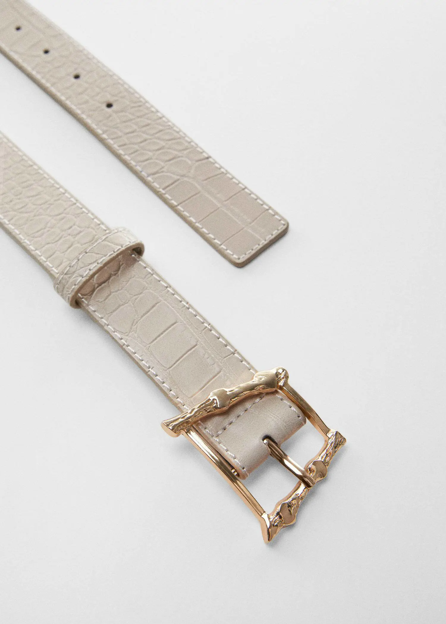 Mango Embossed buckle croc-effect belt. a close-up of a white belt with a gold buckle. 
