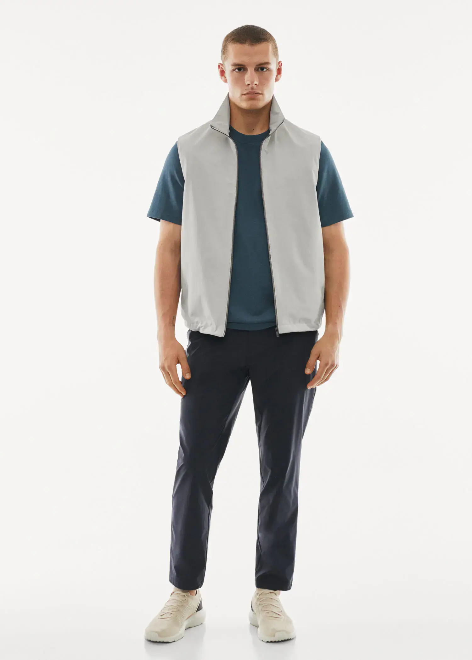 Mango Water-repellent technical vest. a man wearing a white vest and a blue shirt. 