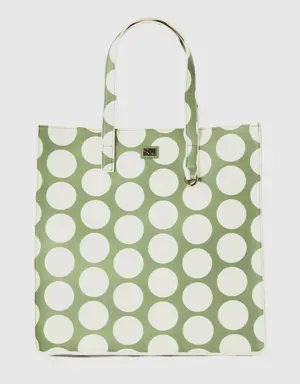 green shopping bag with white polka dots