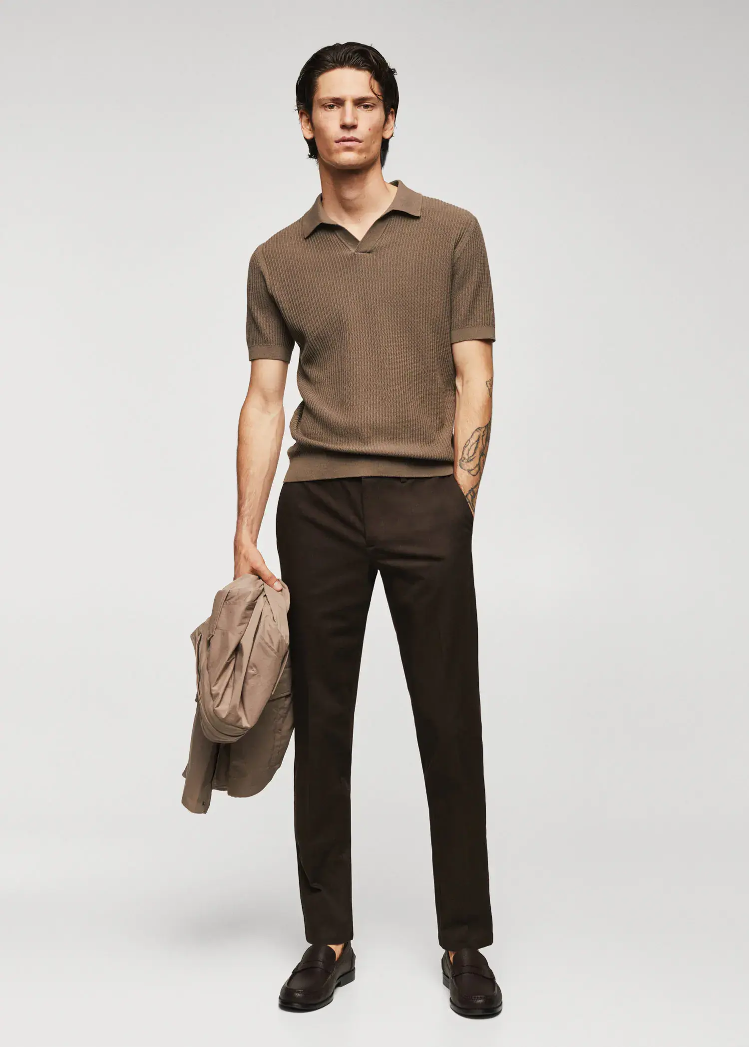 Mango Ribbed cotton polo shirt. a man in a brown polo shirt and black pants. 