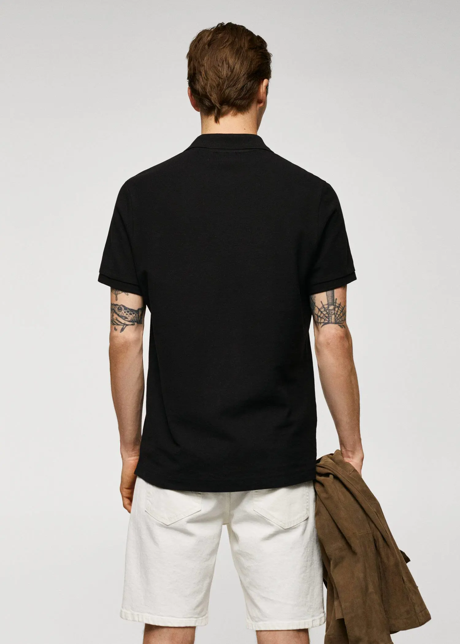 Mango 100% cotton pique polo shirt. a man wearing a black polo shirt and white pants. 