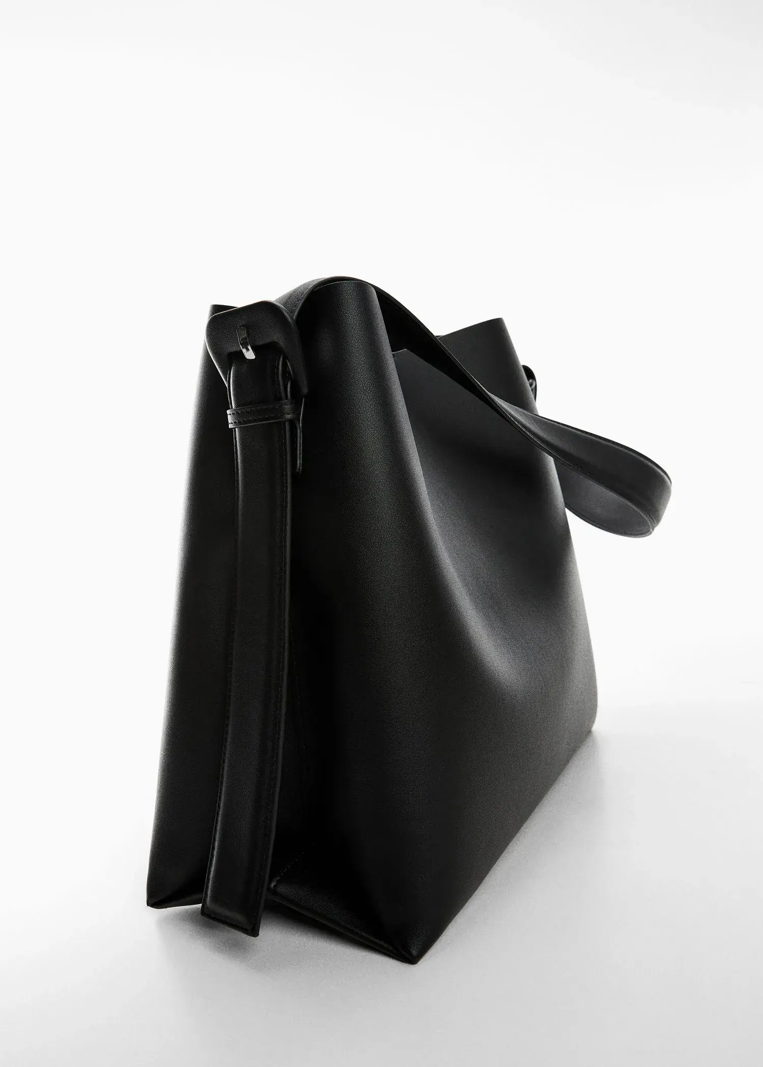 Mango Shopper bag with buckle. a close up of a black purse on a table. 