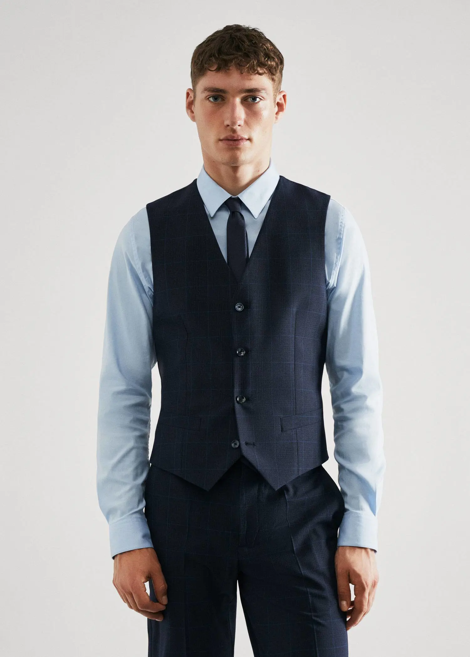 Mango Super slim-fit check suit waistcoat. a young man in a suit and tie. 