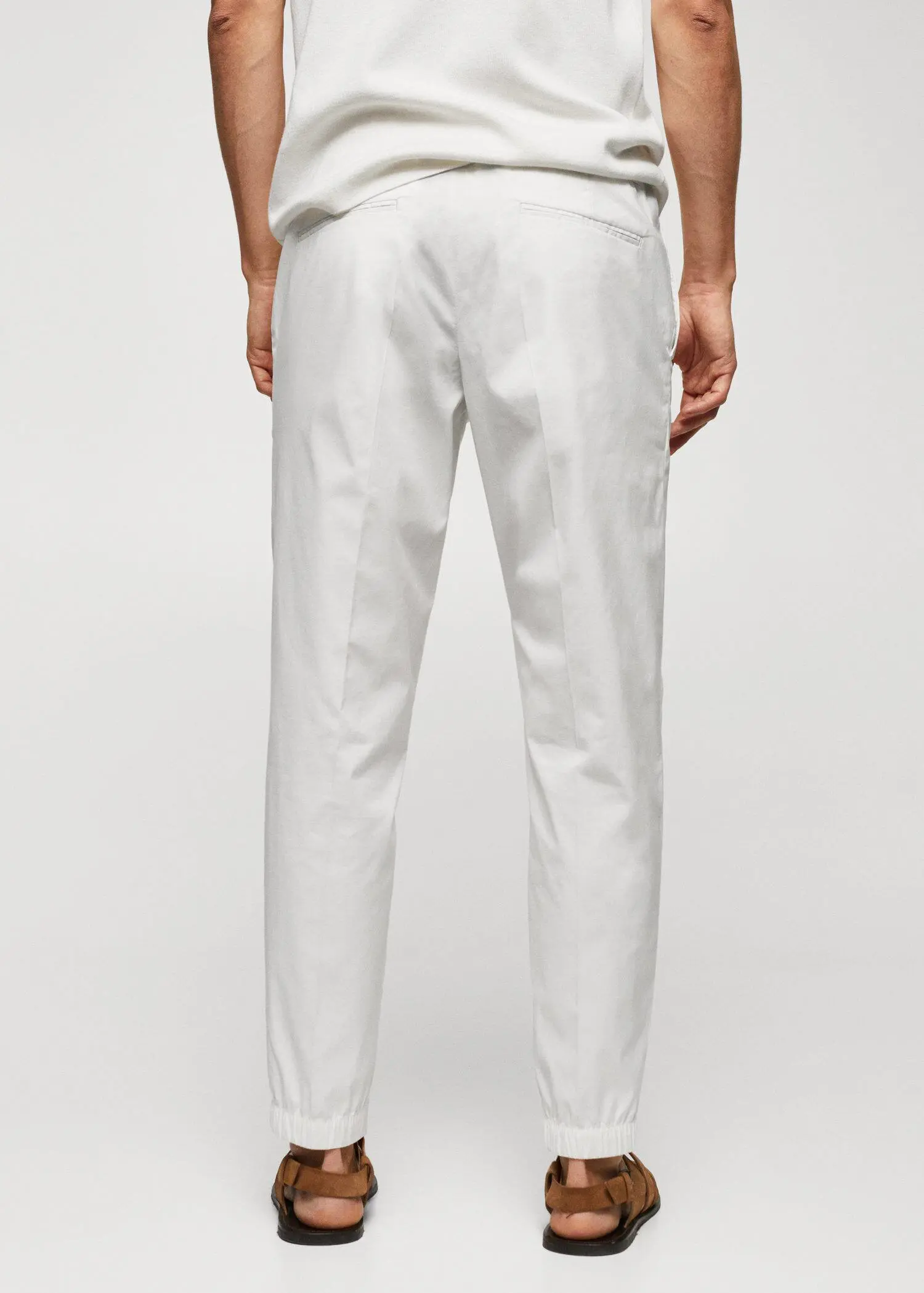 Mango Slim-fit cotton trousers. a person wearing white pants and a white shirt. 