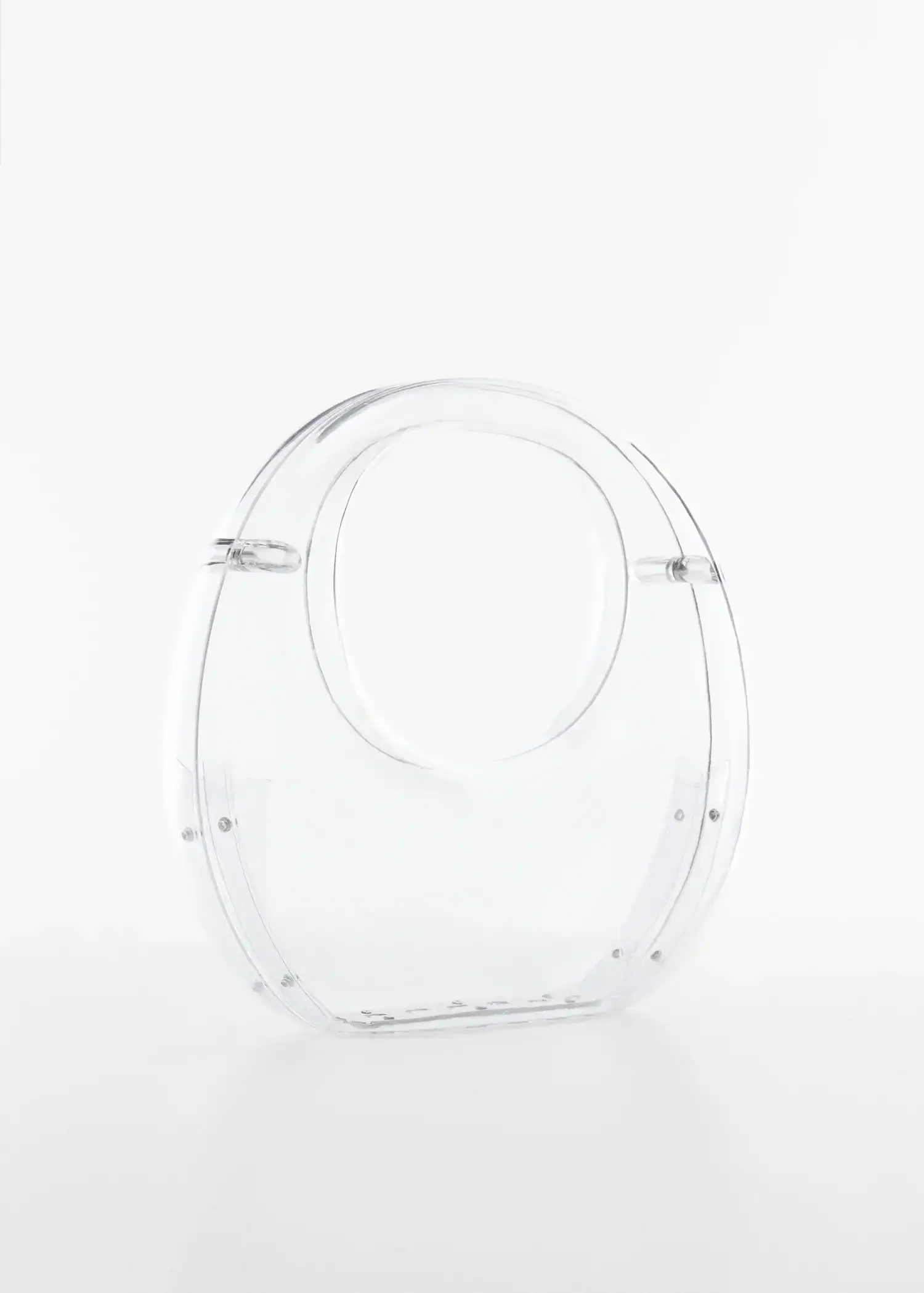 Mango Transparent rigid bag. a clear plastic purse sitting on top of a white table. 