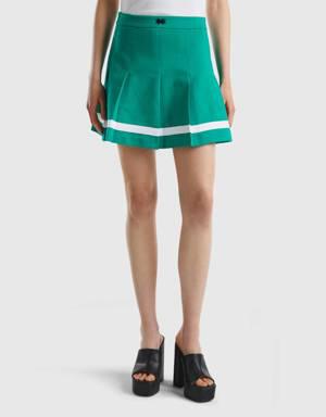 green mini skirt with pleats