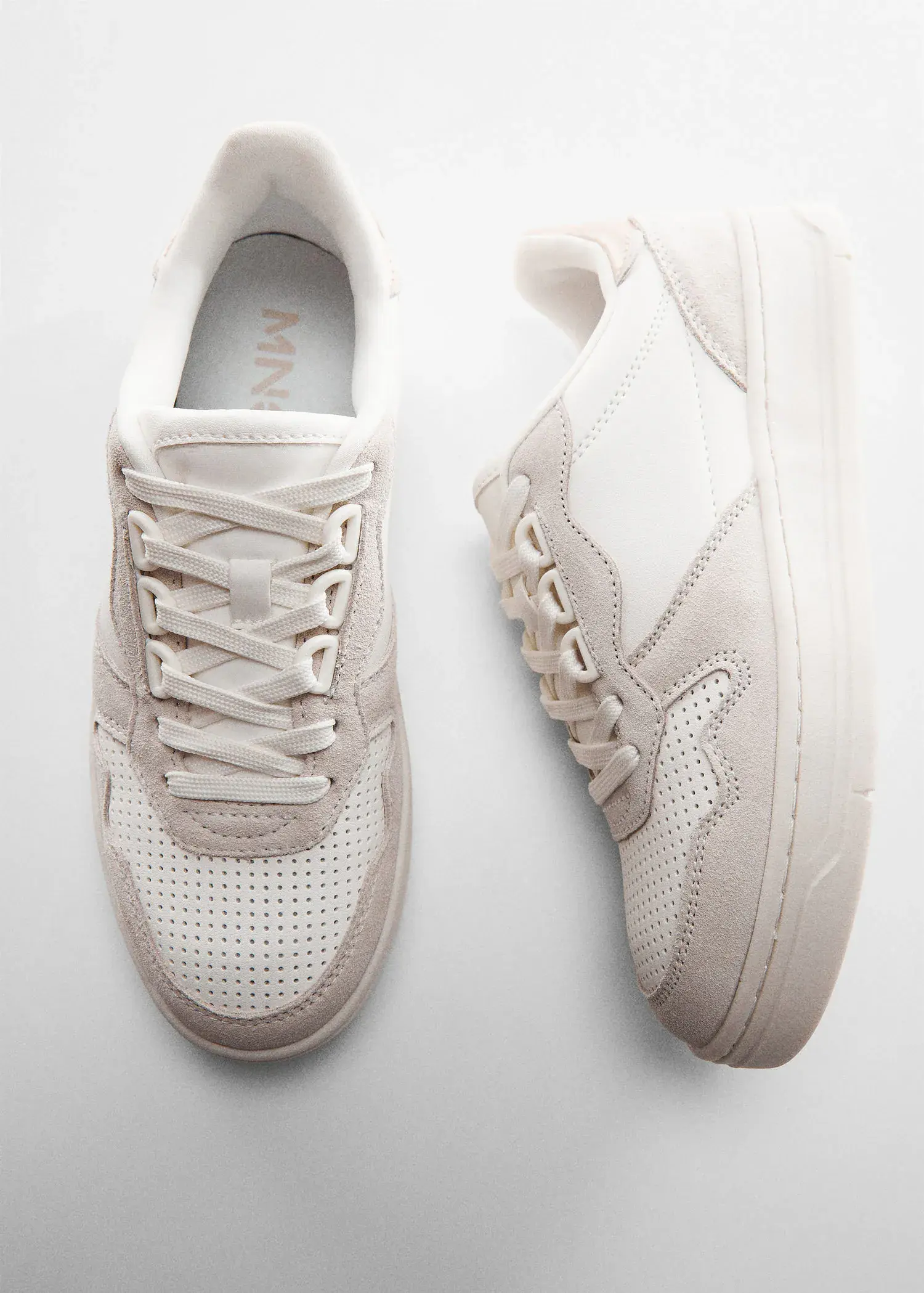 Mango Panels leather sneakers. a pair of white sneakers sitting next to each other on a table. 