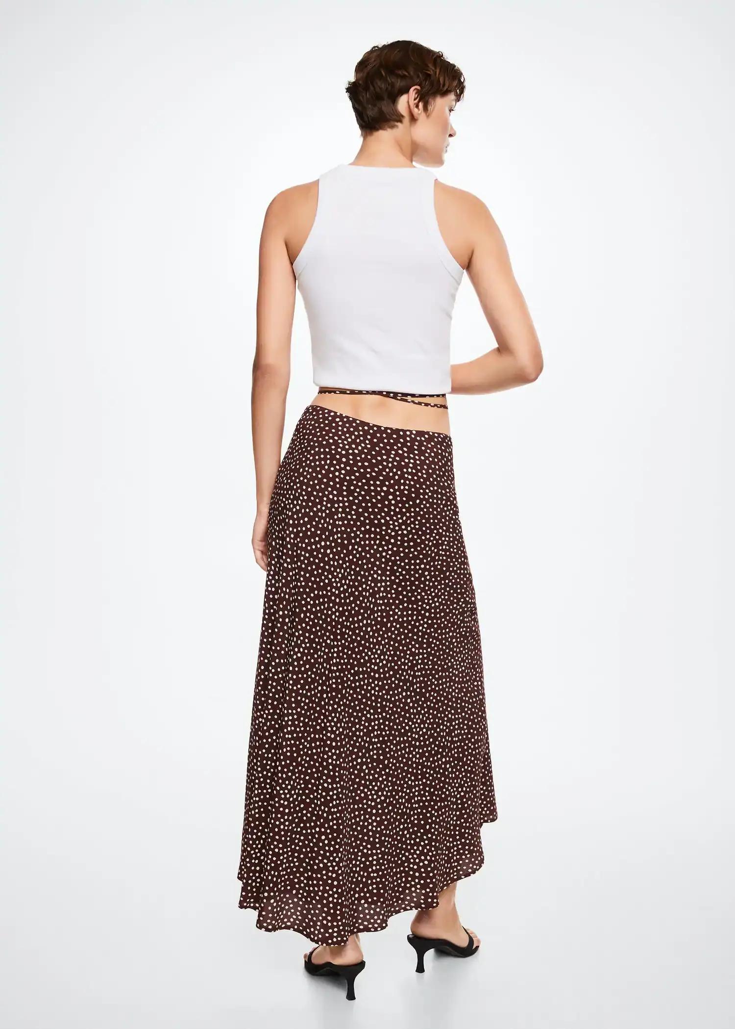 Mango Flowy printed skirt. a woman wearing a white top and a brown skirt. 