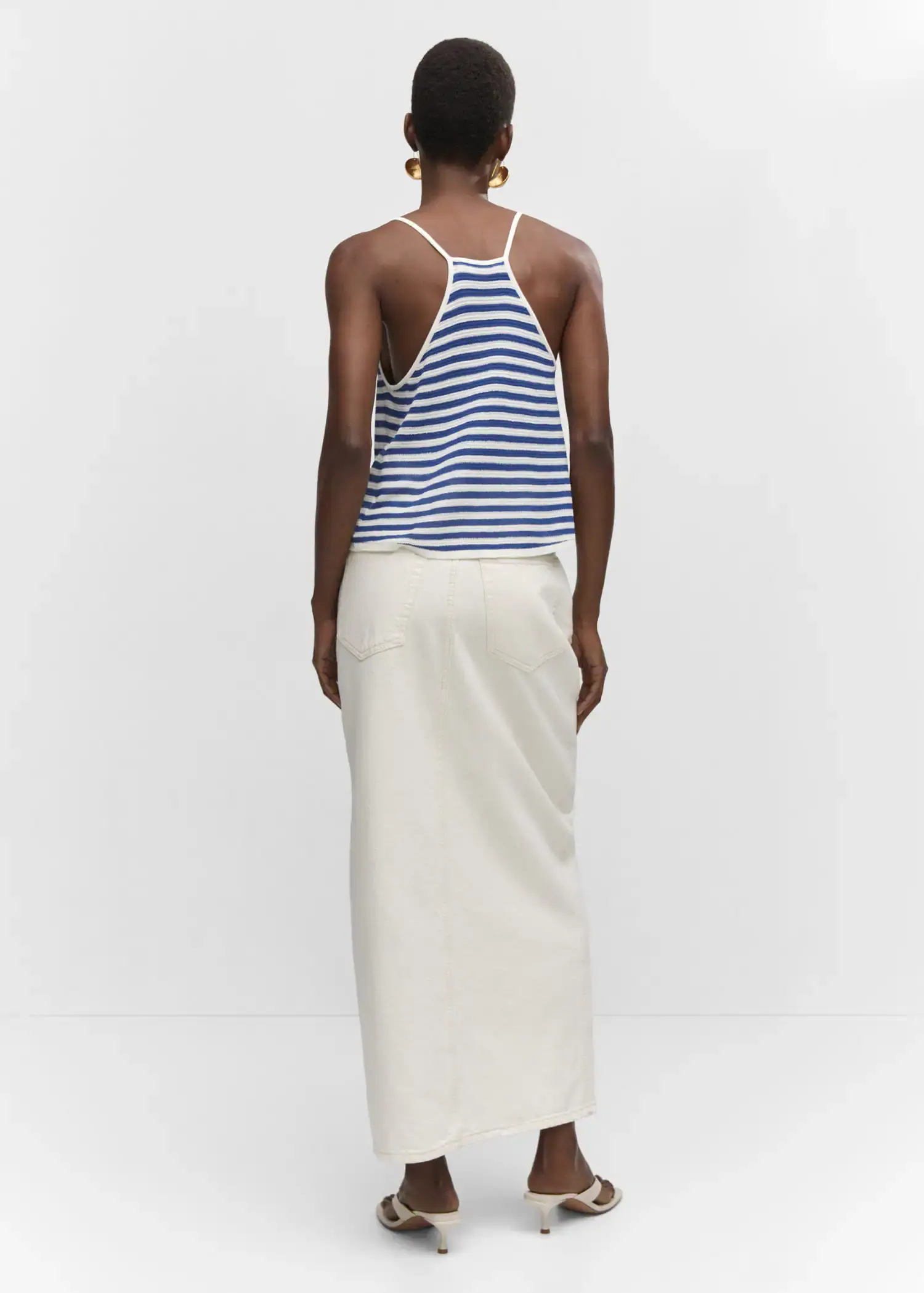 Mango Striped knit top. a woman wearing a long white skirt and a blue and white striped tank top. 
