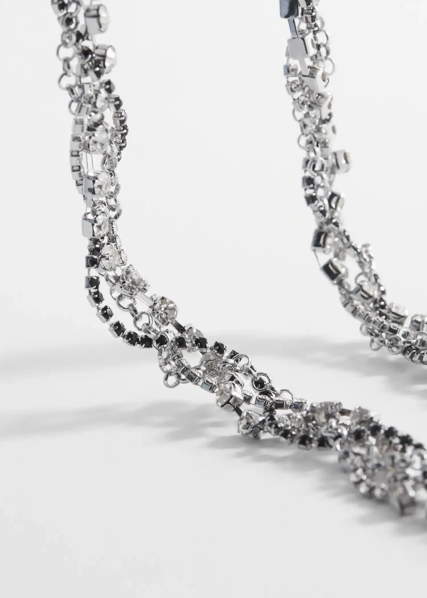 Mango Rhinestone intertwined necklace. a close-up view of a silver chain. 