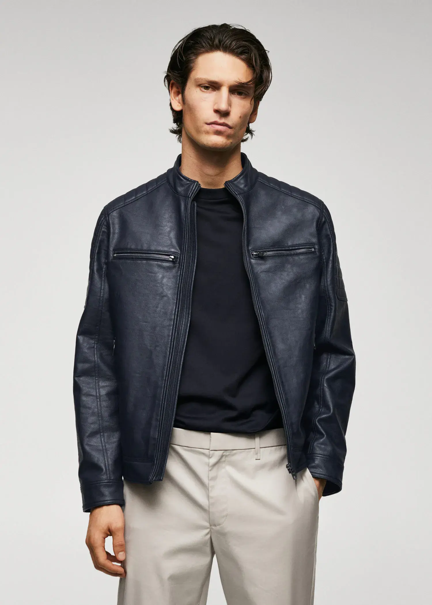 Mango Nappa leather-effect jacket. a man wearing a black jacket and white pants. 