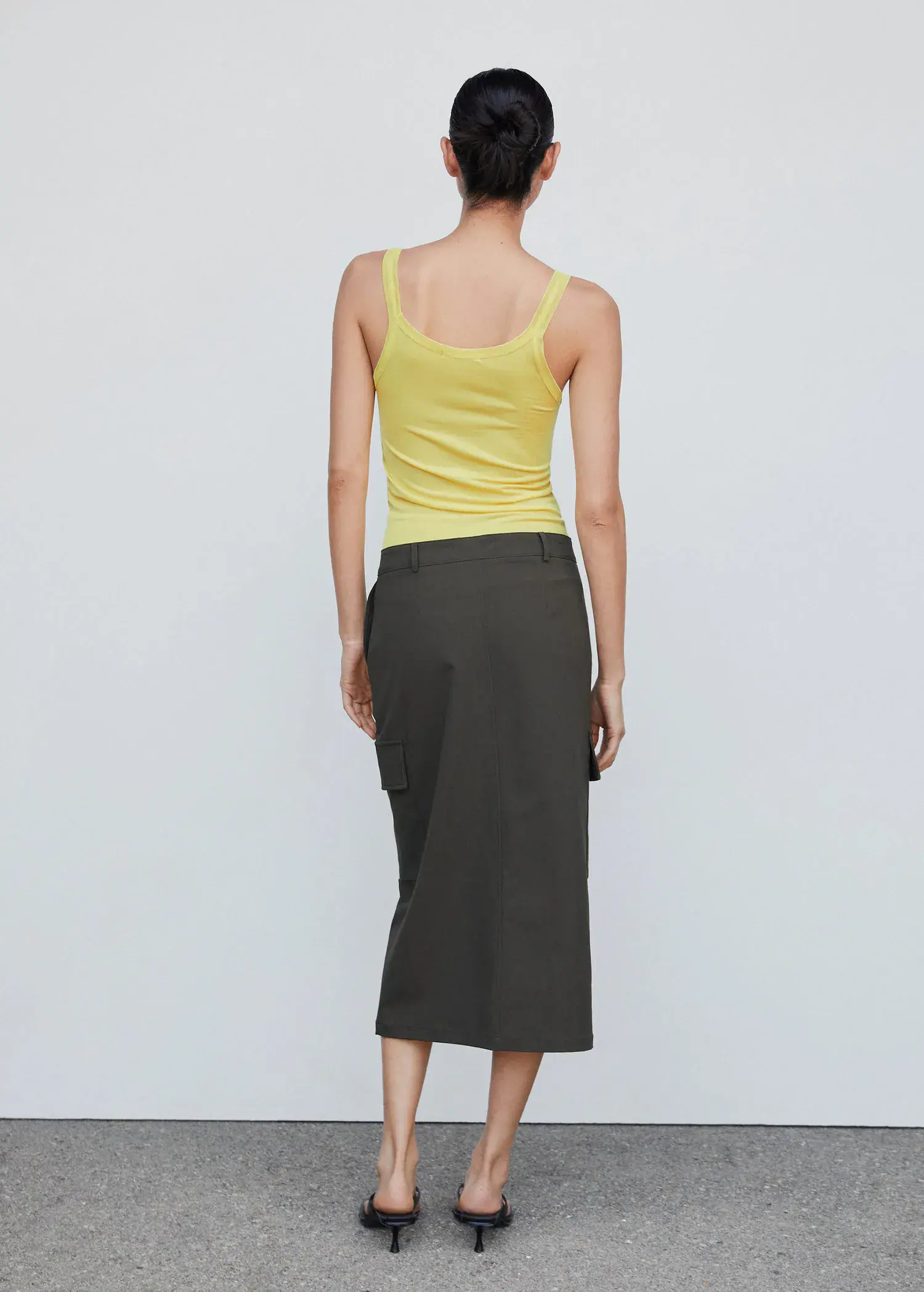 Mango Ribbed strap top. a woman in a yellow shirt and a black skirt. 