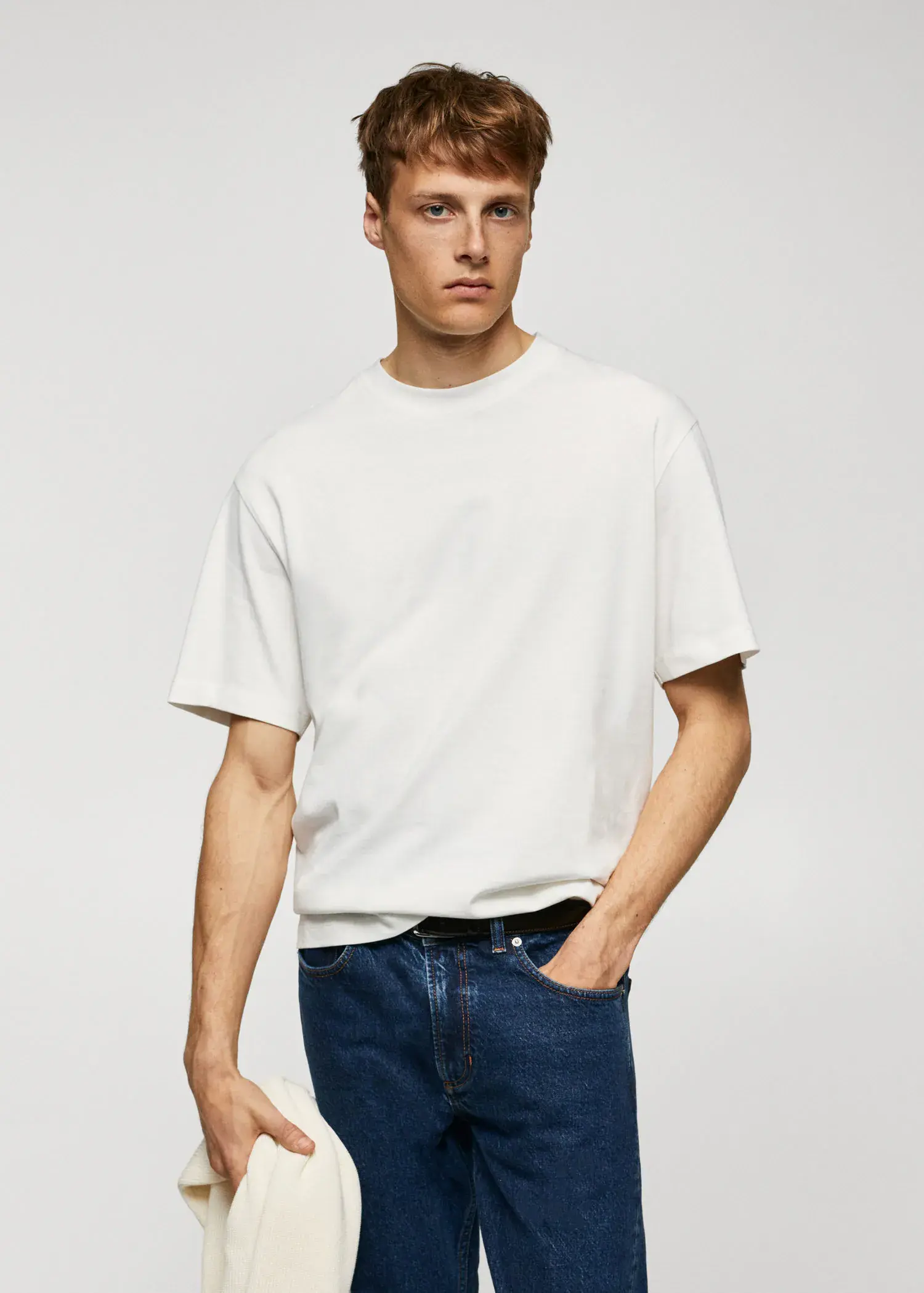 Mango Basic 100% cotton relaxed-fit t-shirt. a man in a white t-shirt and blue jeans. 