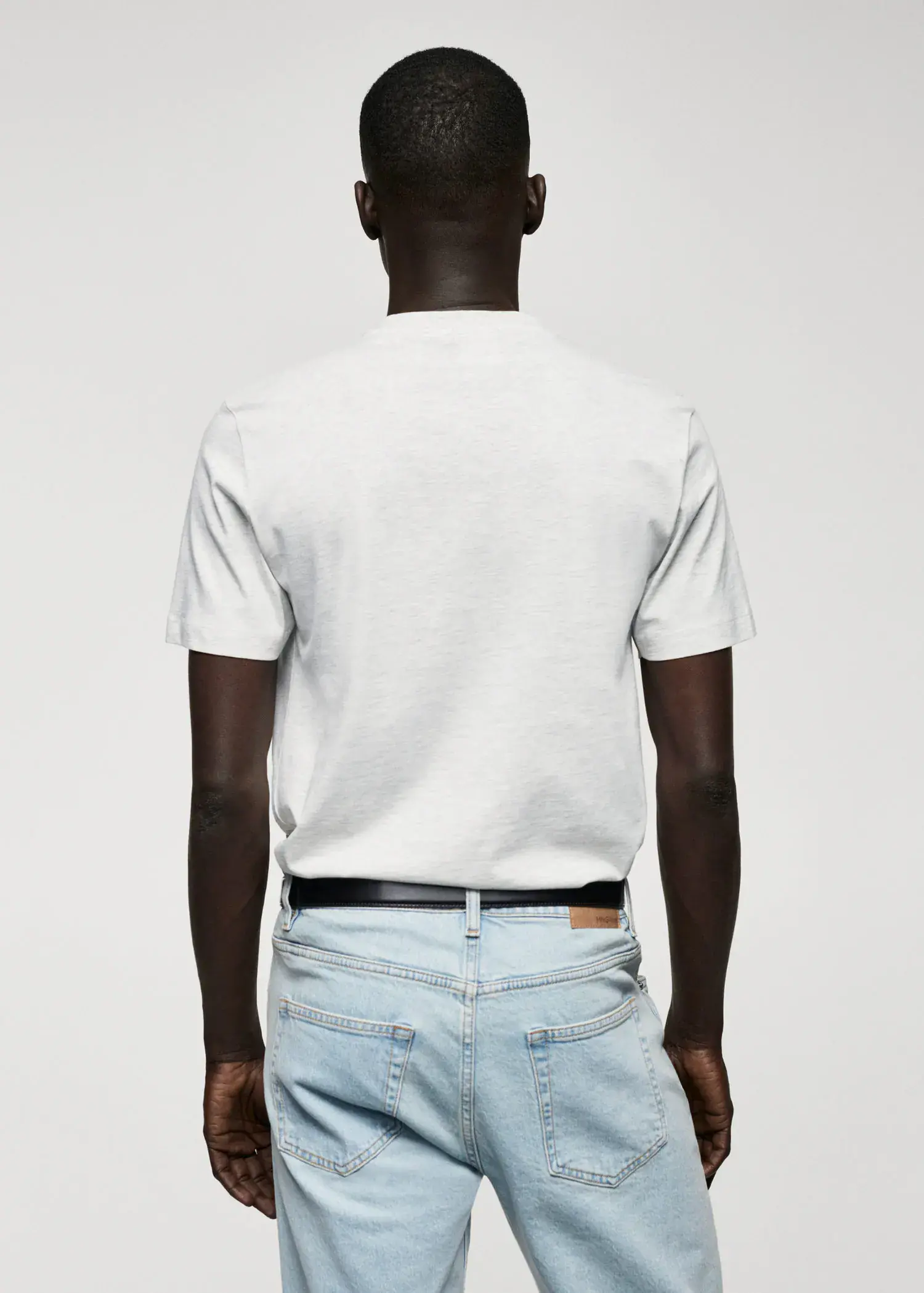 Mango Basic cotton V-neck T-shirt. a man wearing a white shirt and jeans. 