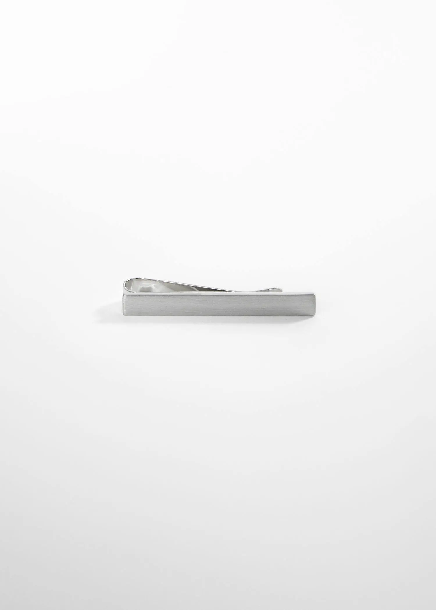 Mango Metal tie clip. a silver tie bar sitting on top of a table. 