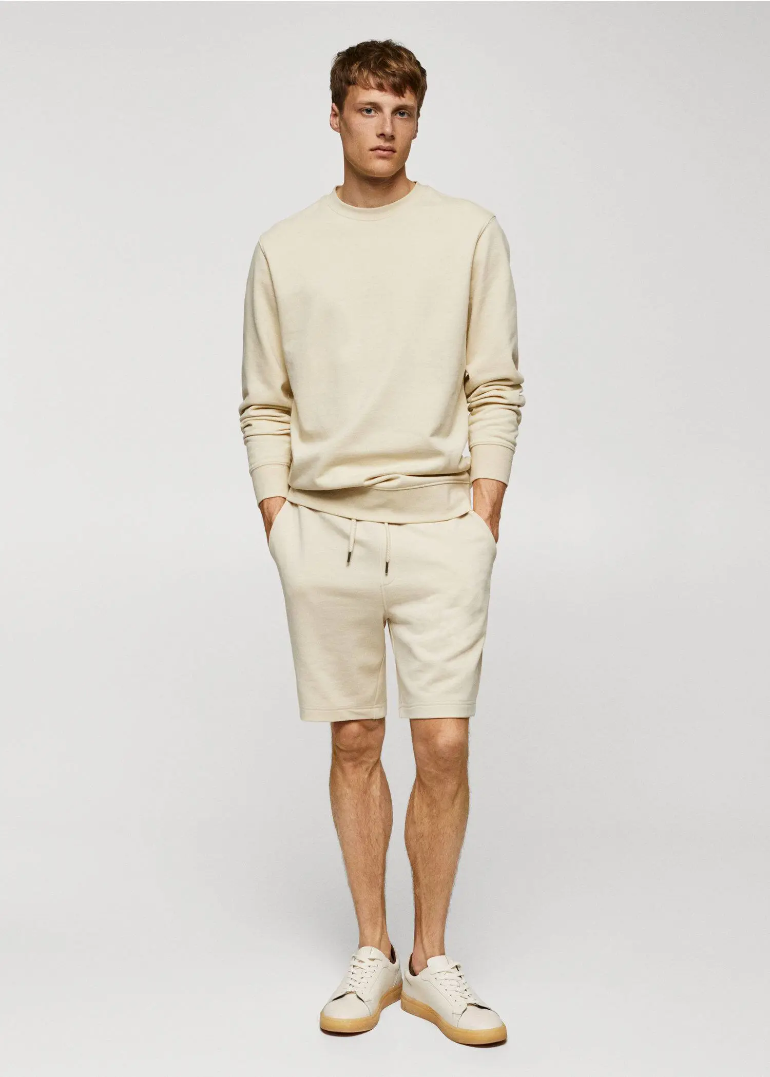 Mango 100% cotton basic sweatshirt . a man in a beige outfit stands in front of a white wall. 