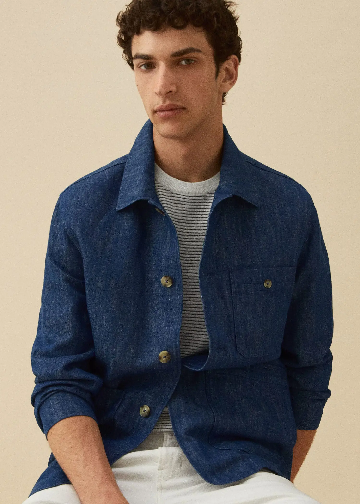 Mango Cotton-linen jacket with pockets. a young man wearing a blue jacket and striped shirt. 