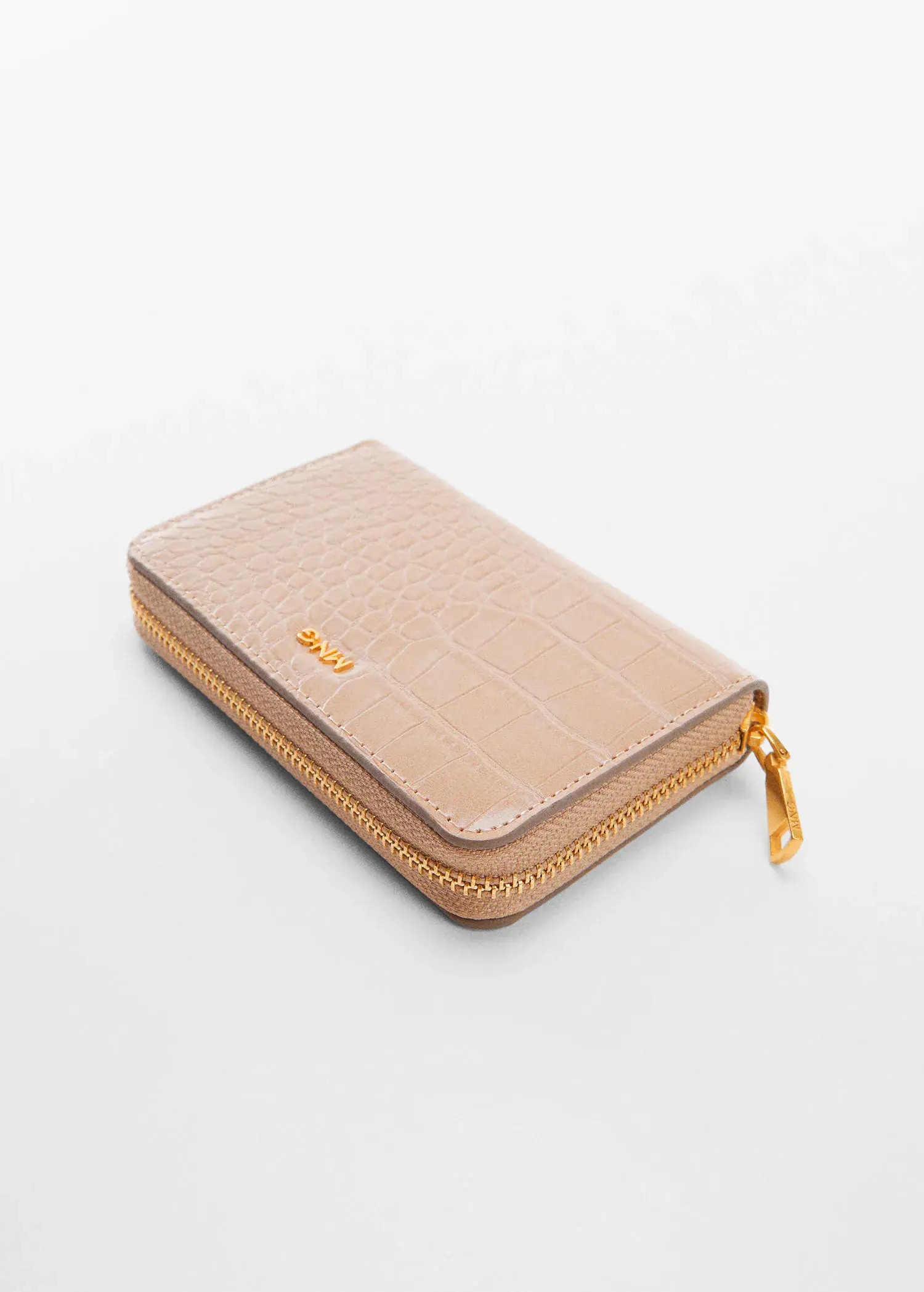 Mango Animal print effect wallet. a beige wallet is sitting on a white surface. 