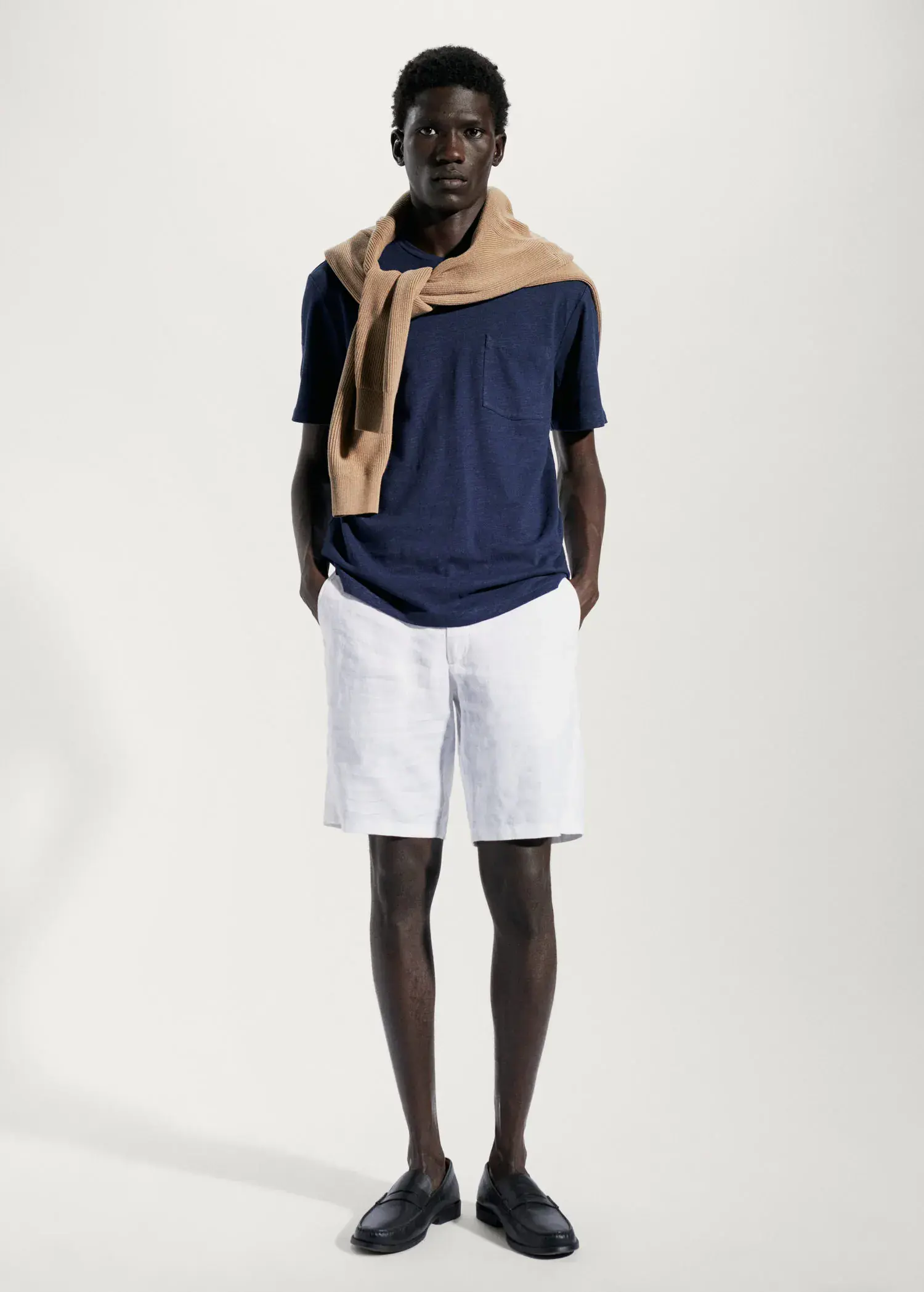 Mango Cotton-linen pocket t-shirt. a man wearing a blue shirt and white shorts. 
