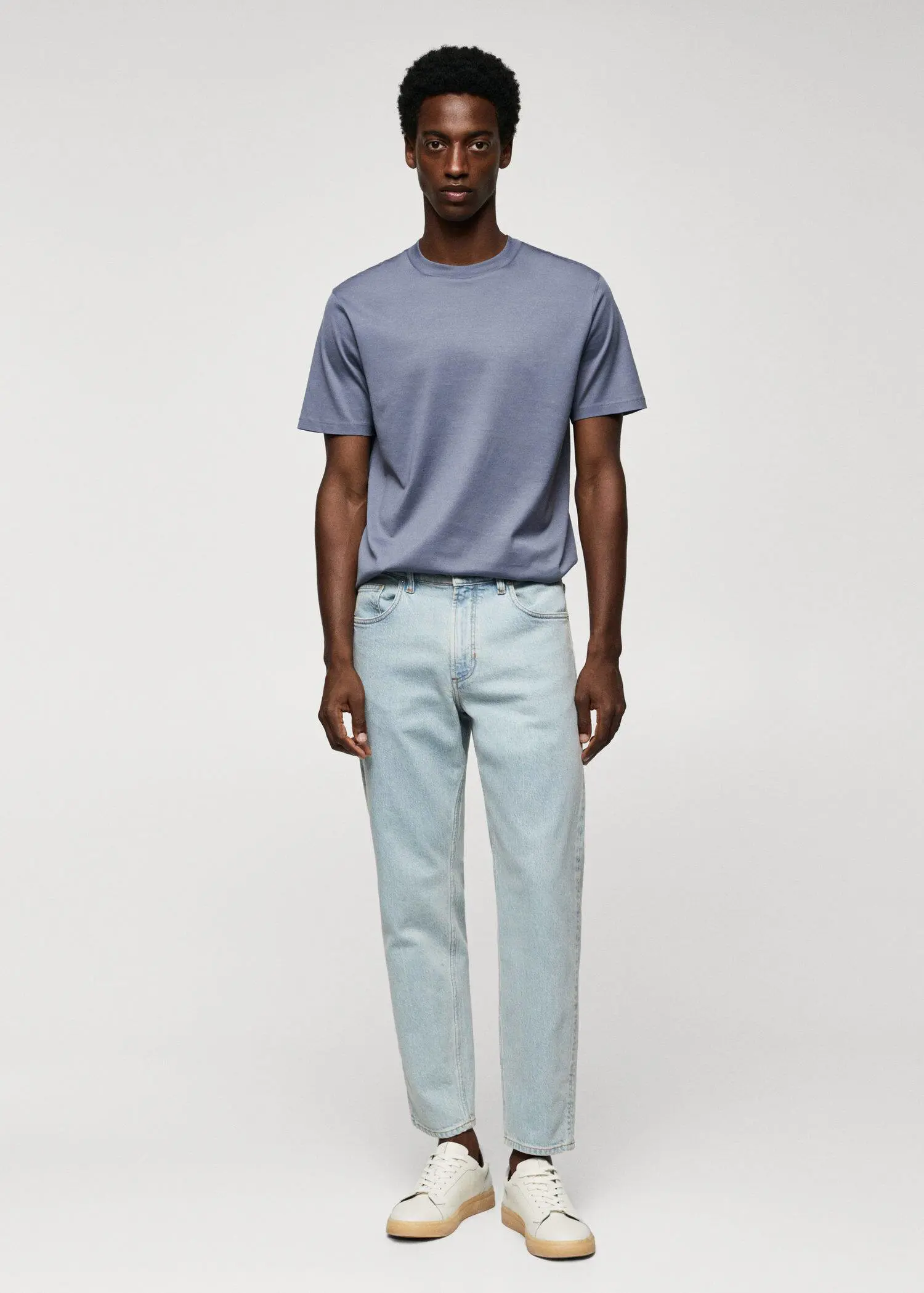 Mango Ben tapered cropped jeans. a man wearing a blue shirt and blue pants. 