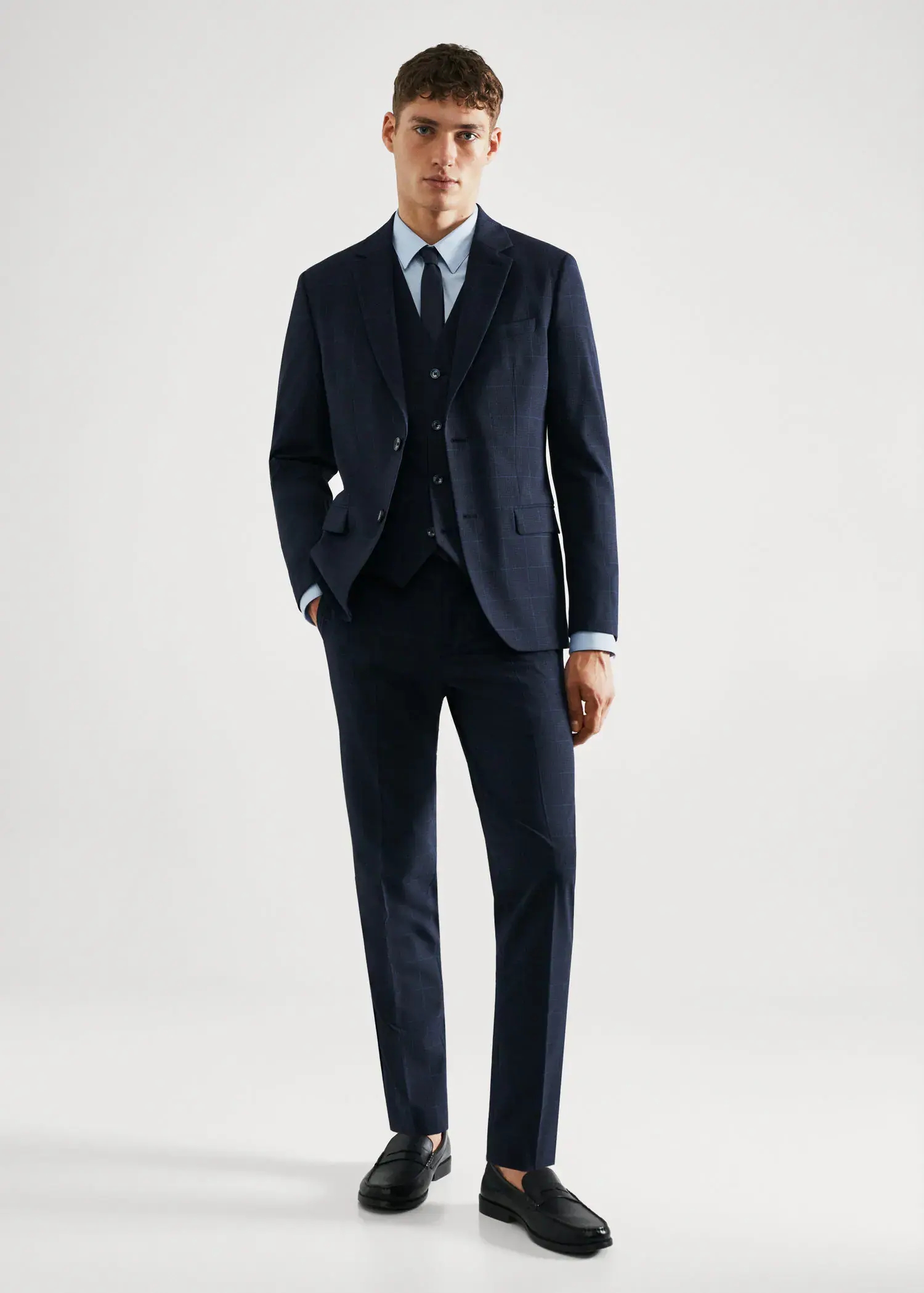 Mango Super slim-fit check suit jacket. a man wearing a suit and tie standing in a room. 