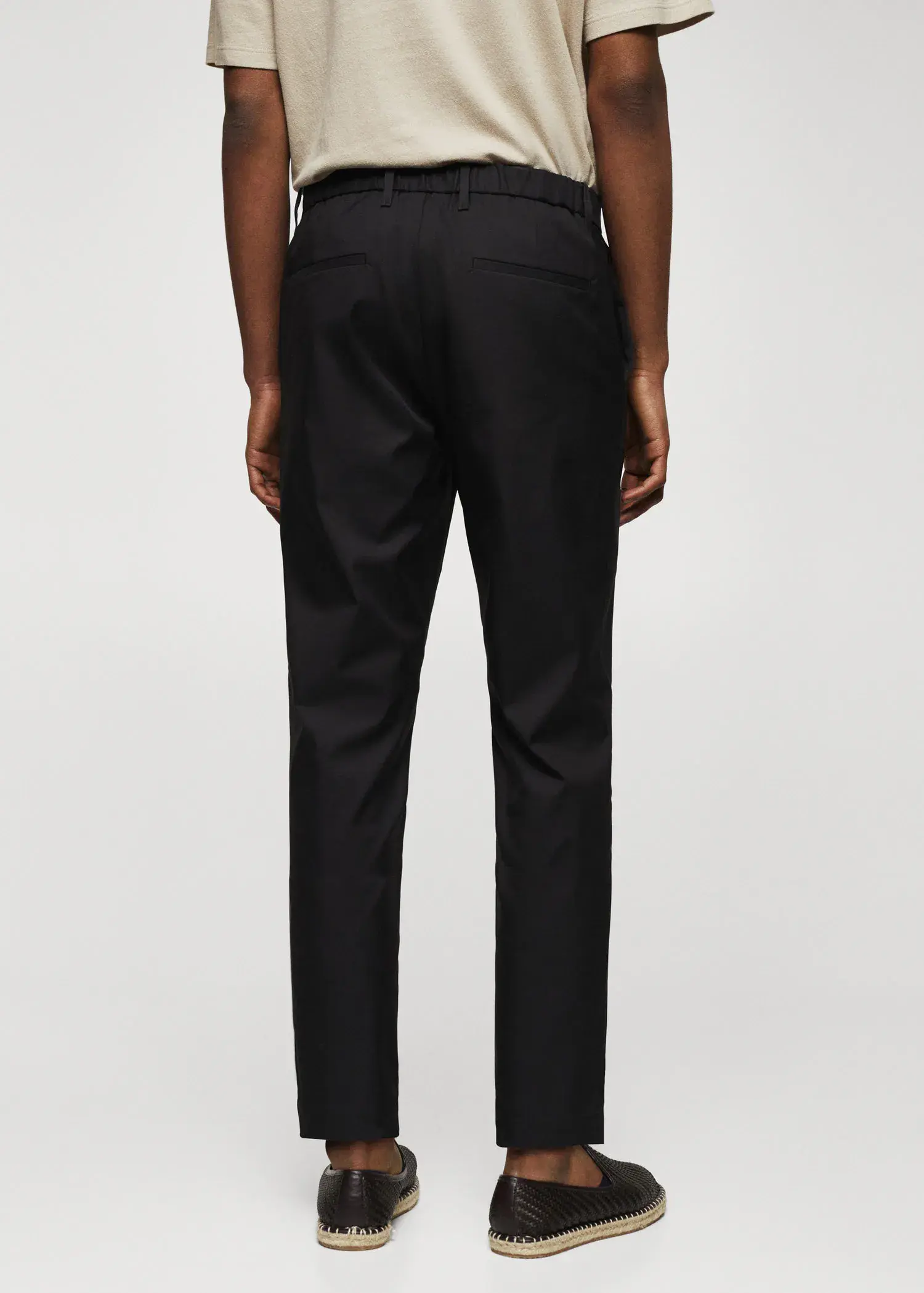 Mango Slim-fit cotton pants. a person wearing black pants and a white shirt. 