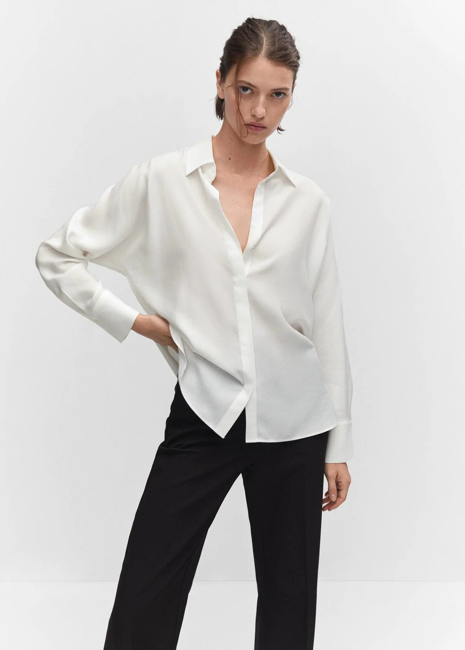 Mango Lyocell fluid shirt. a woman wearing a white shirt and black pants. 