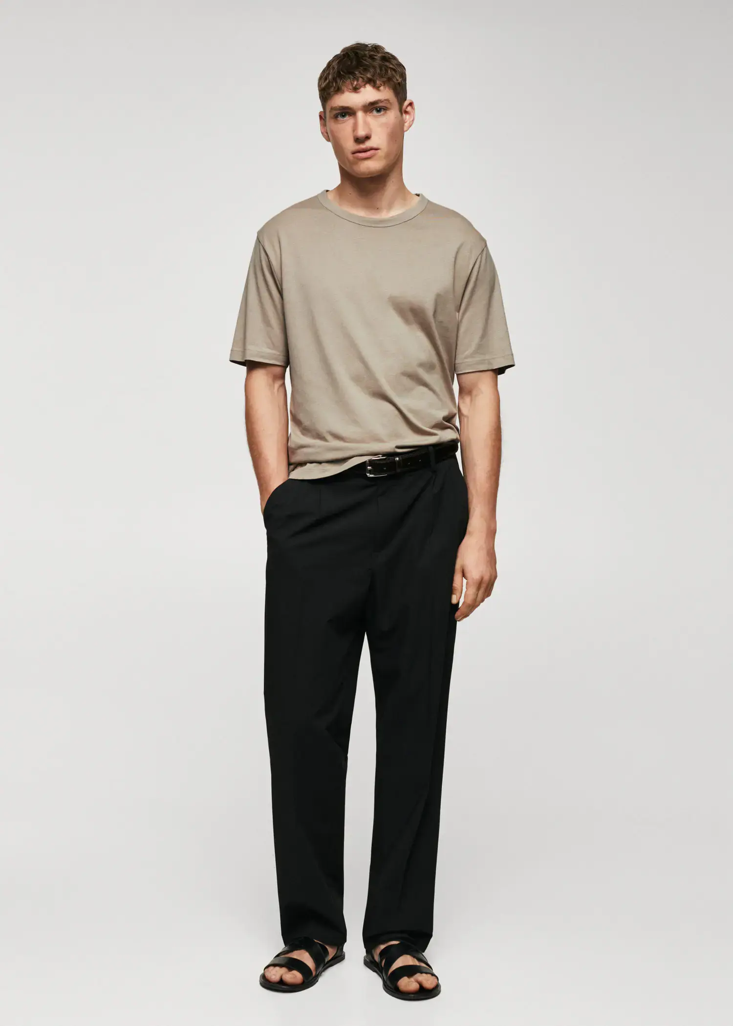 Mango Basic mercerized lightweight shirt. a man in a tan t-shirt and black pants. 