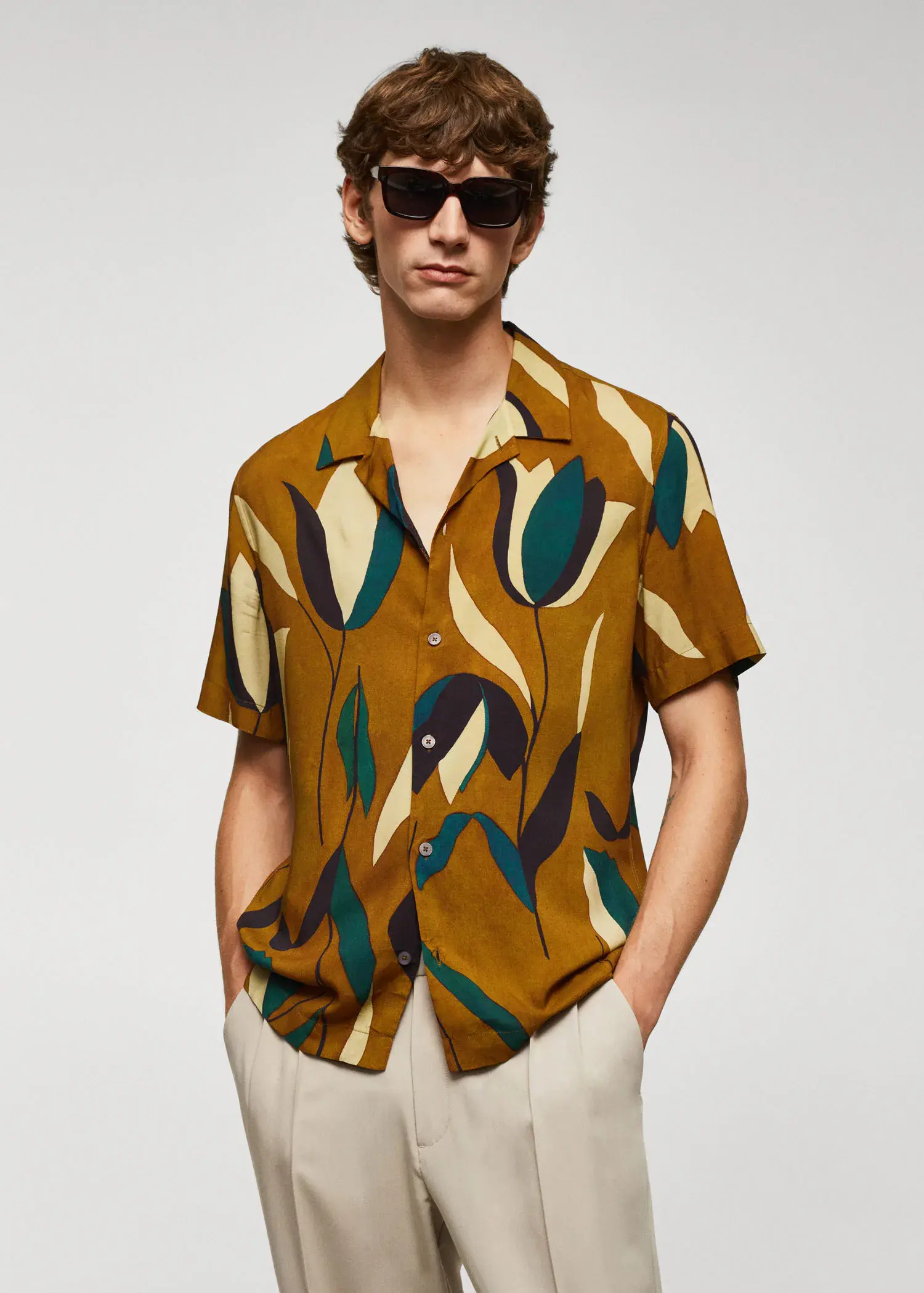 Mango Printed bowling shirt. a man wearing a brown shirt and sunglasses. 