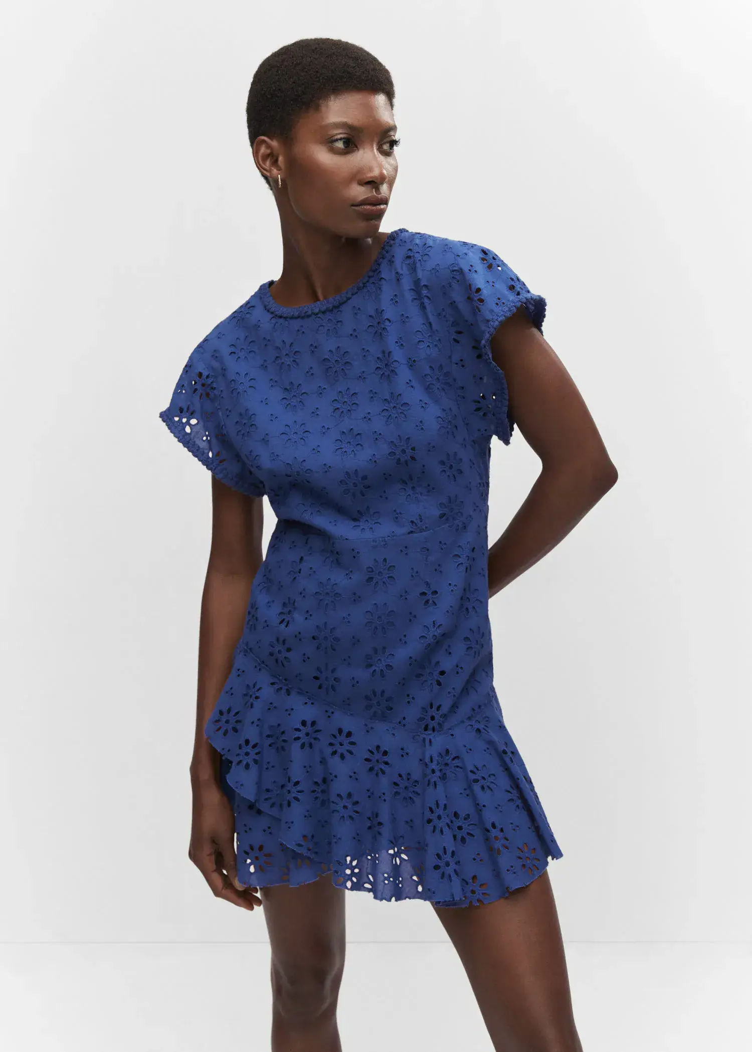 Mango Embroidered openwork dress. a woman wearing a blue dress standing in front of a wall. 