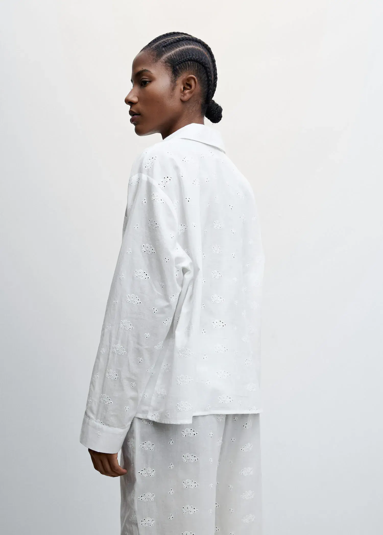 Mango Pajama shirt with openwork details. a person wearing a white shirt and white pants. 