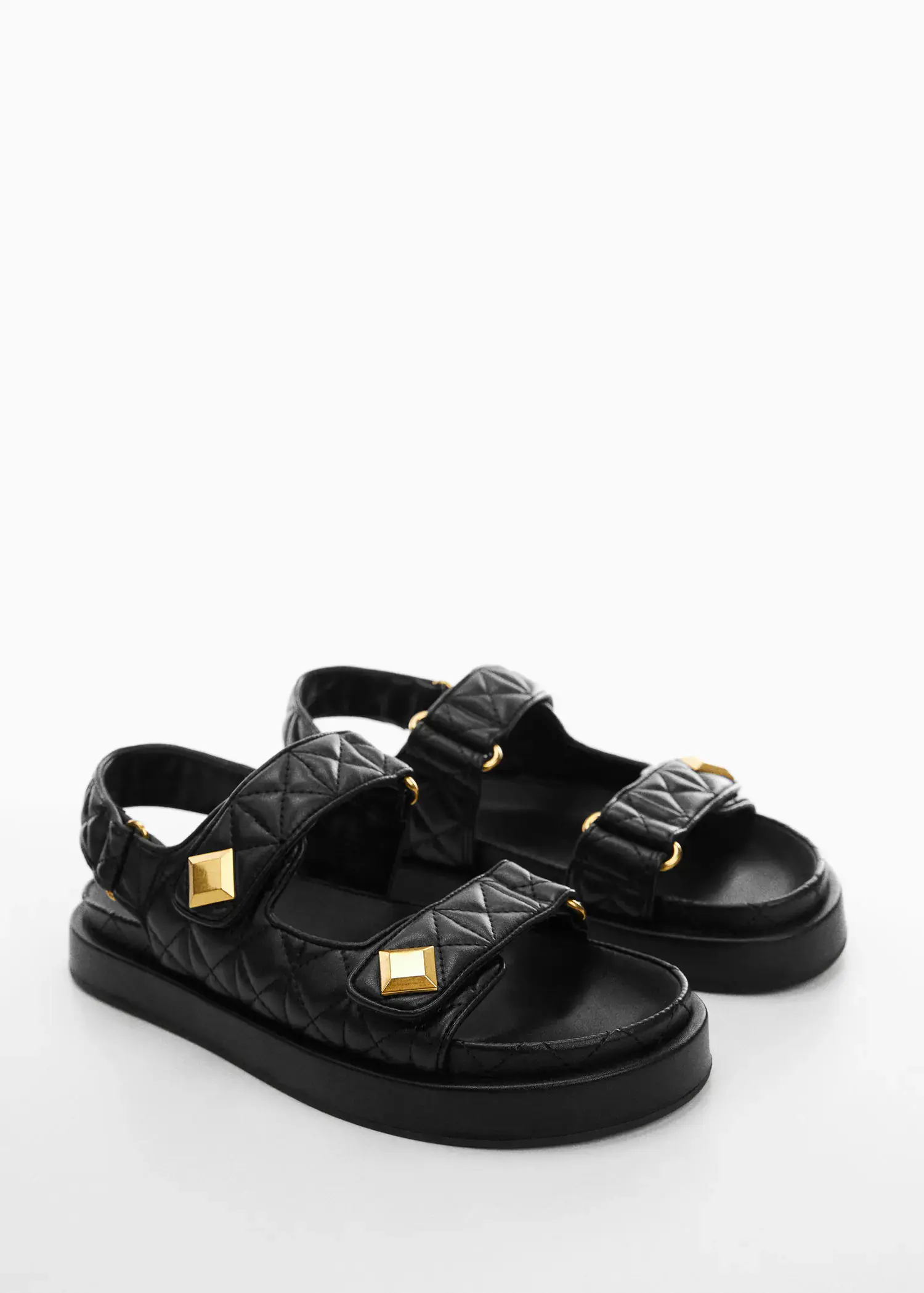 Mango Velcro padded sandal. a pair of black sandals on a white surface. 