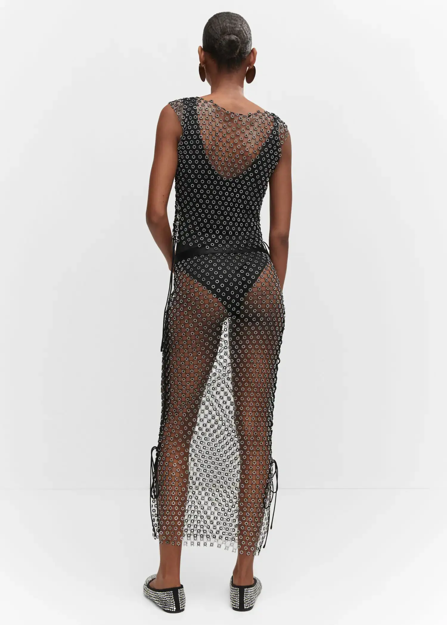 Mango Top crystals. a woman wearing a black dress with white polka dots. 