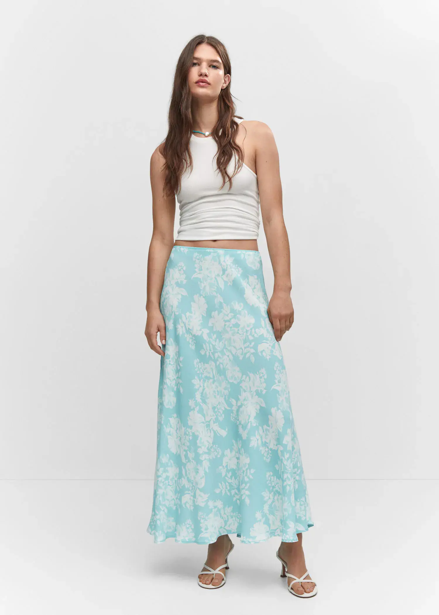 Mango Floral long skirt. a woman standing in front of a white wall. 