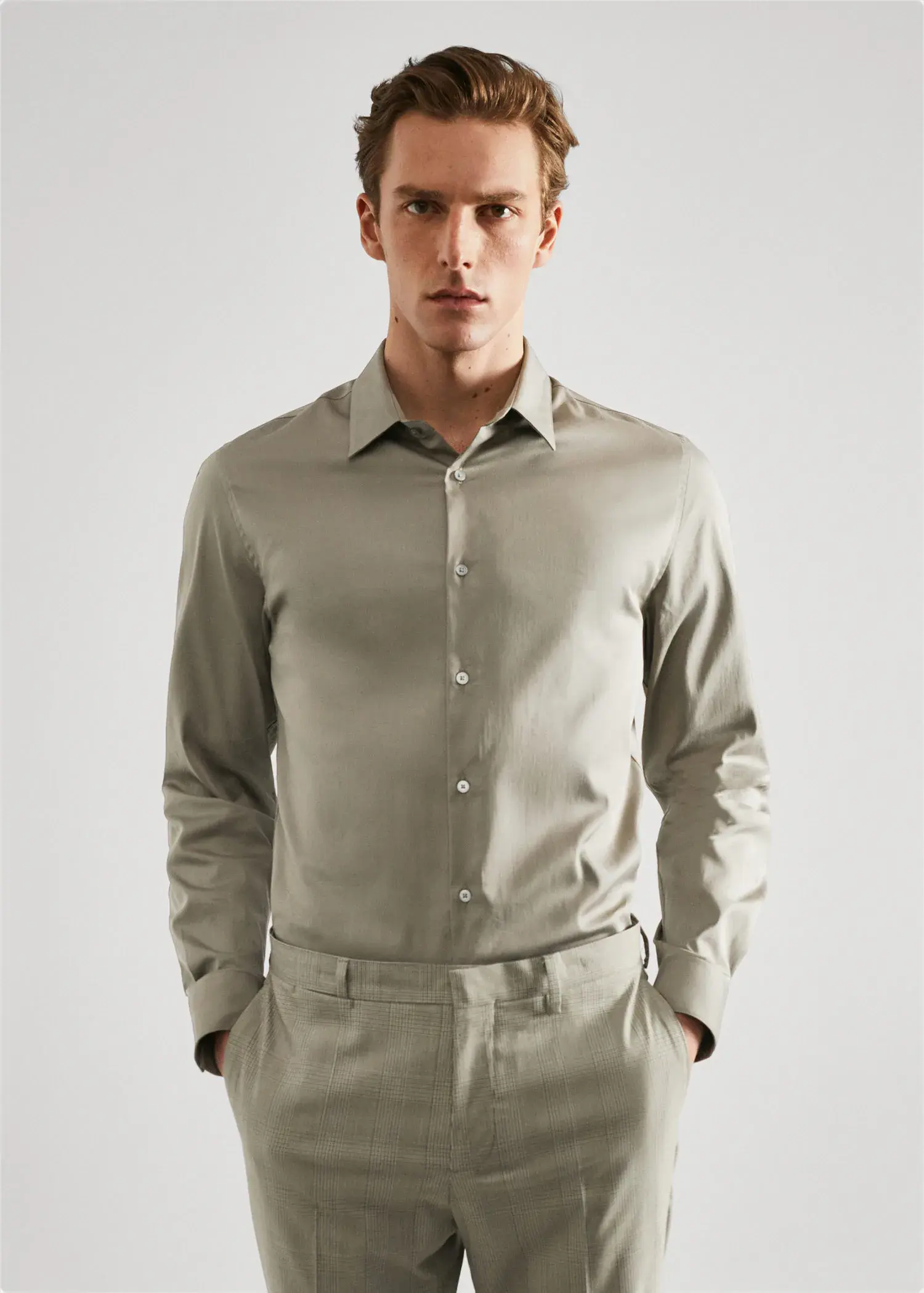 Mango Super slim-fit poplin suit shirt. a man in a tan suit is posing for a picture. 