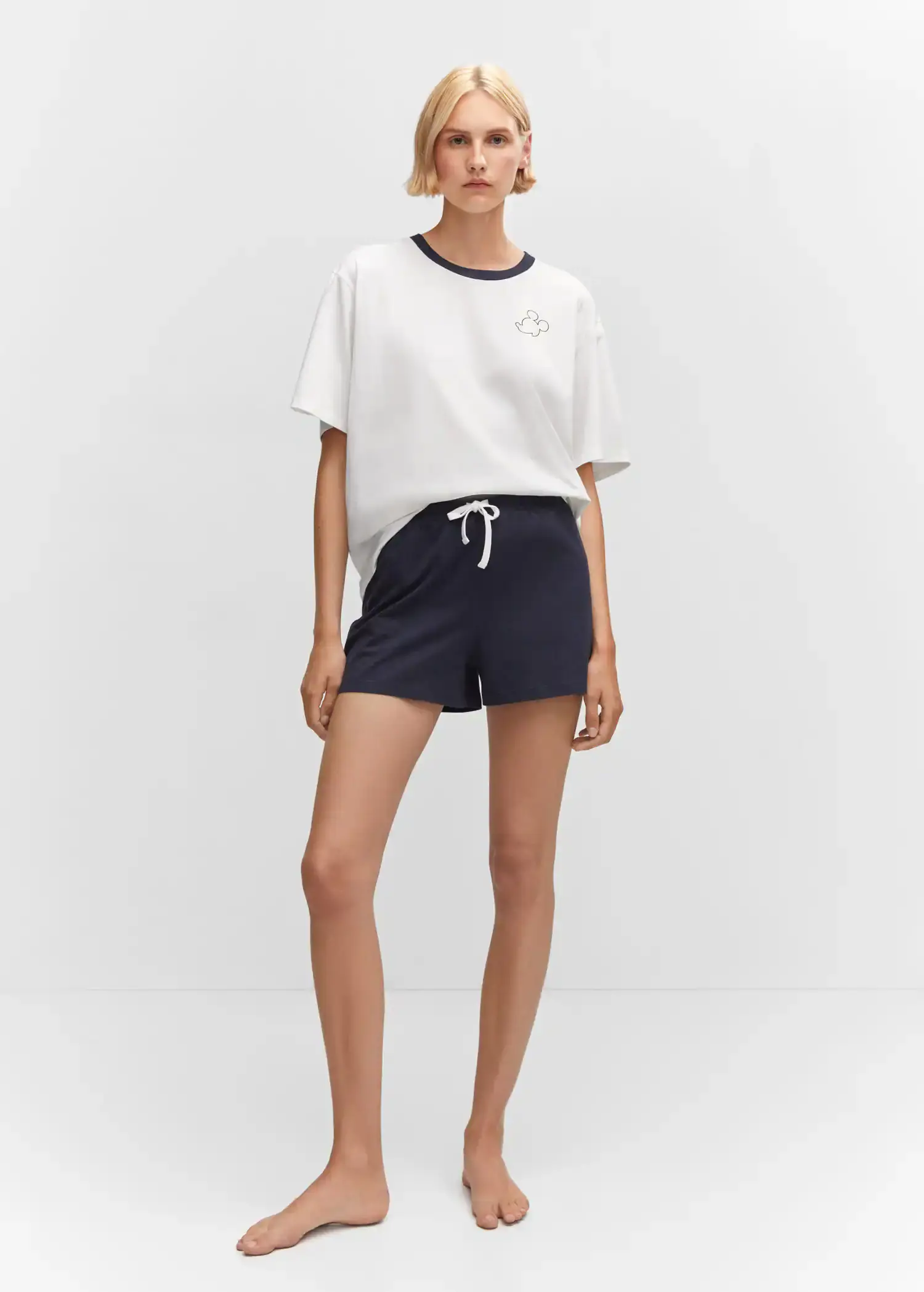 Mango Cotton shorts with elastic waist. a woman in a white t-shirt and black shorts. 