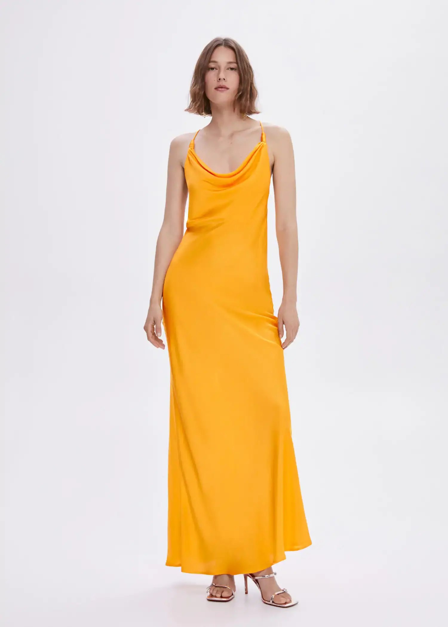Mango Draped neck satin dress. a woman in a yellow dress standing in front of a white wall. 