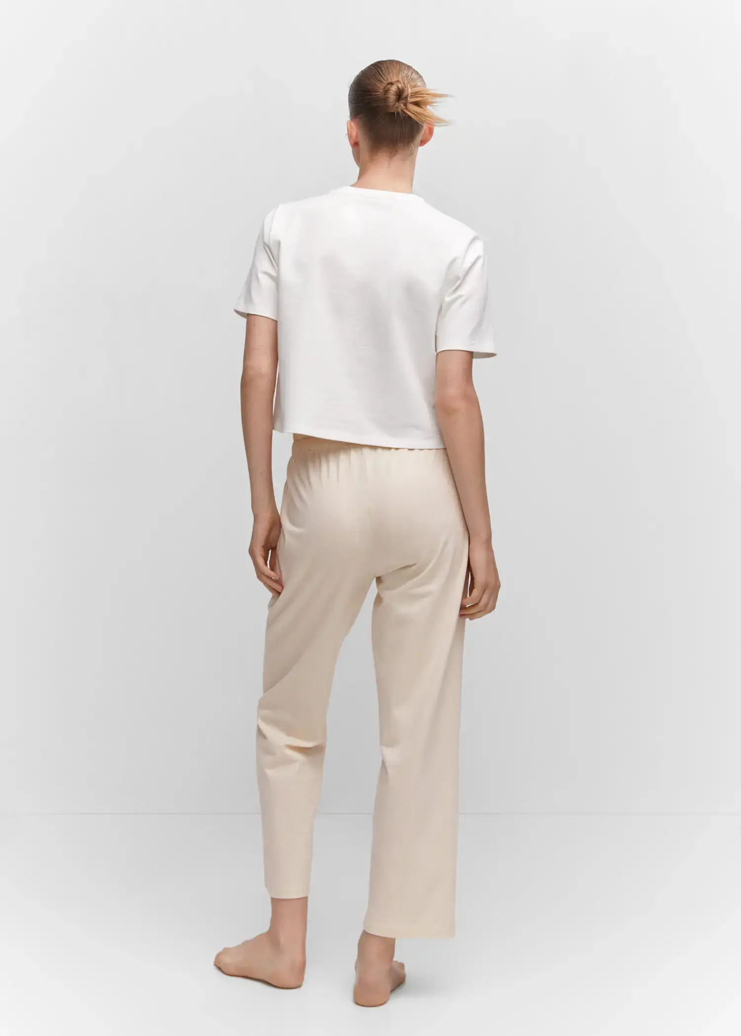 Mango Cotton-knit trousers. a person wearing a white shirt and white pants. 
